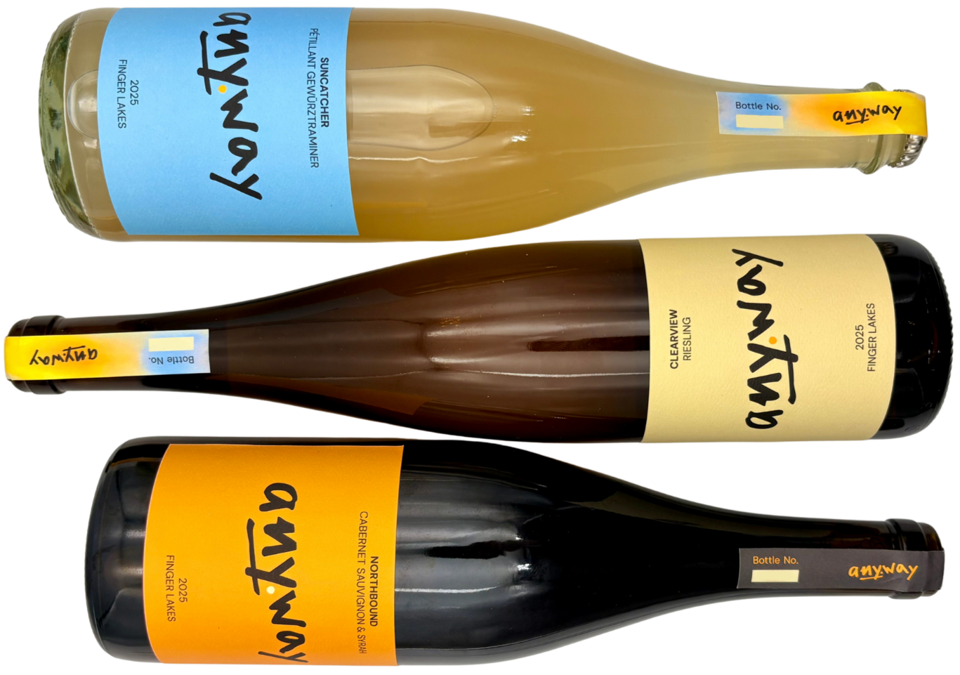 Three bottles of wine lying horizontally with labels indicating 3 different varieties from the 2025 vintage of Anyway: the Suncatcher Gewurztraminer, the Clearview Riesling, and the Northbound Cabernet Sauvignon-Syrah blend.