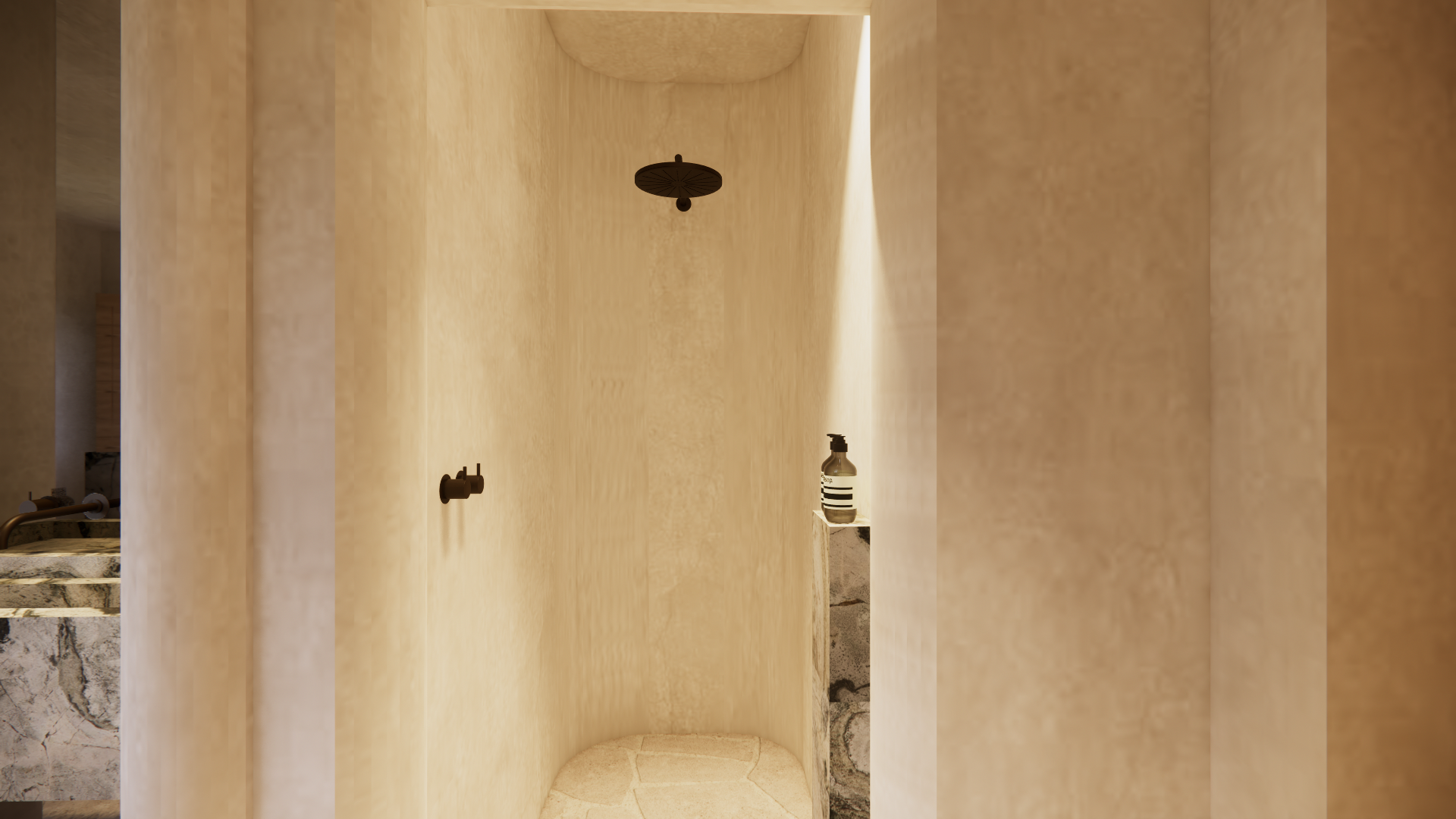 Minimalist shower area with beige walls, a black ceiling shower head, and a small shelf with a bottle.