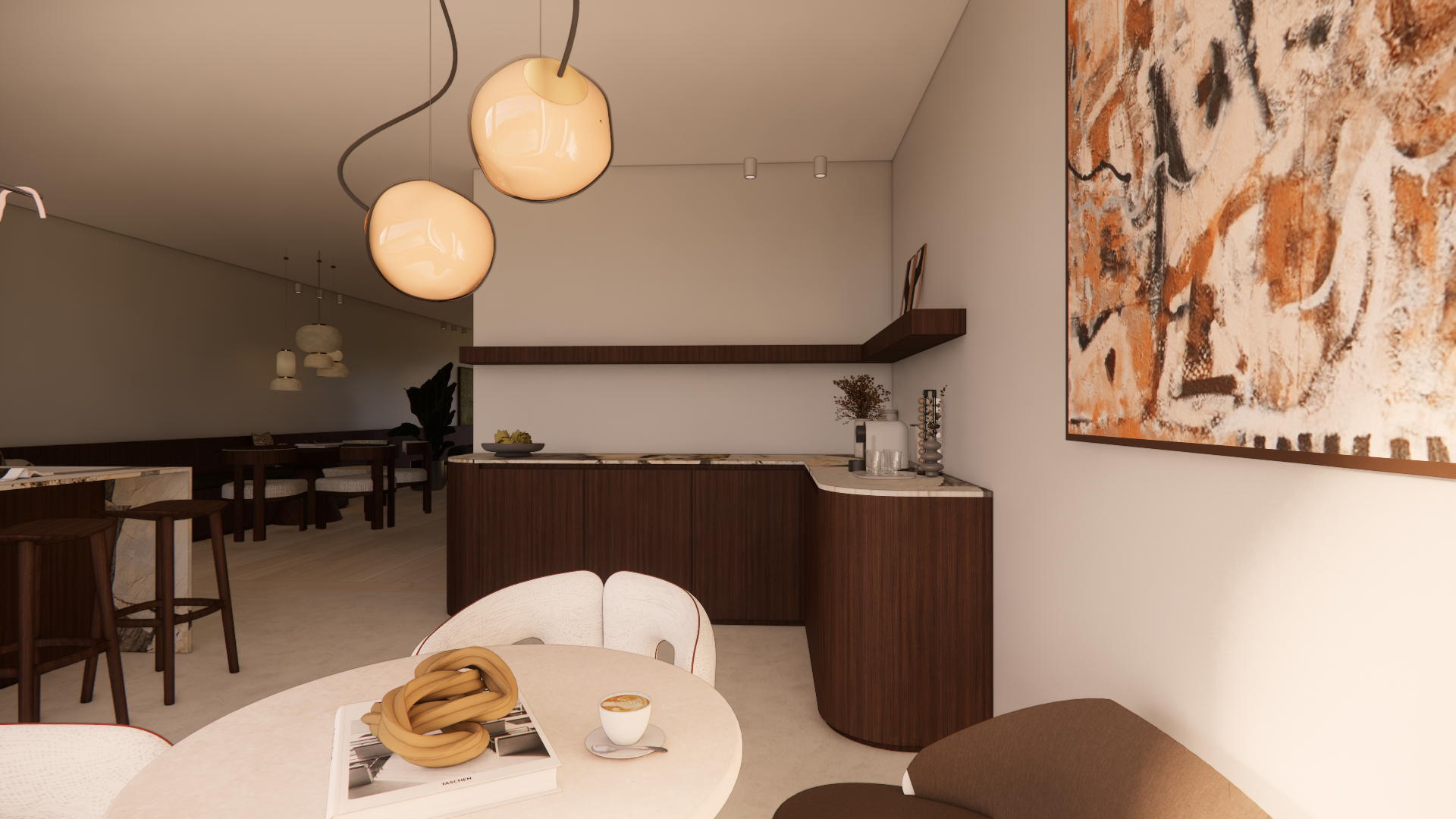 Modern open-concept kitchen and dining area with pendant lights, abstract artwork, and a cozy seating corner with a round table, a cup of coffee, and a magazine.