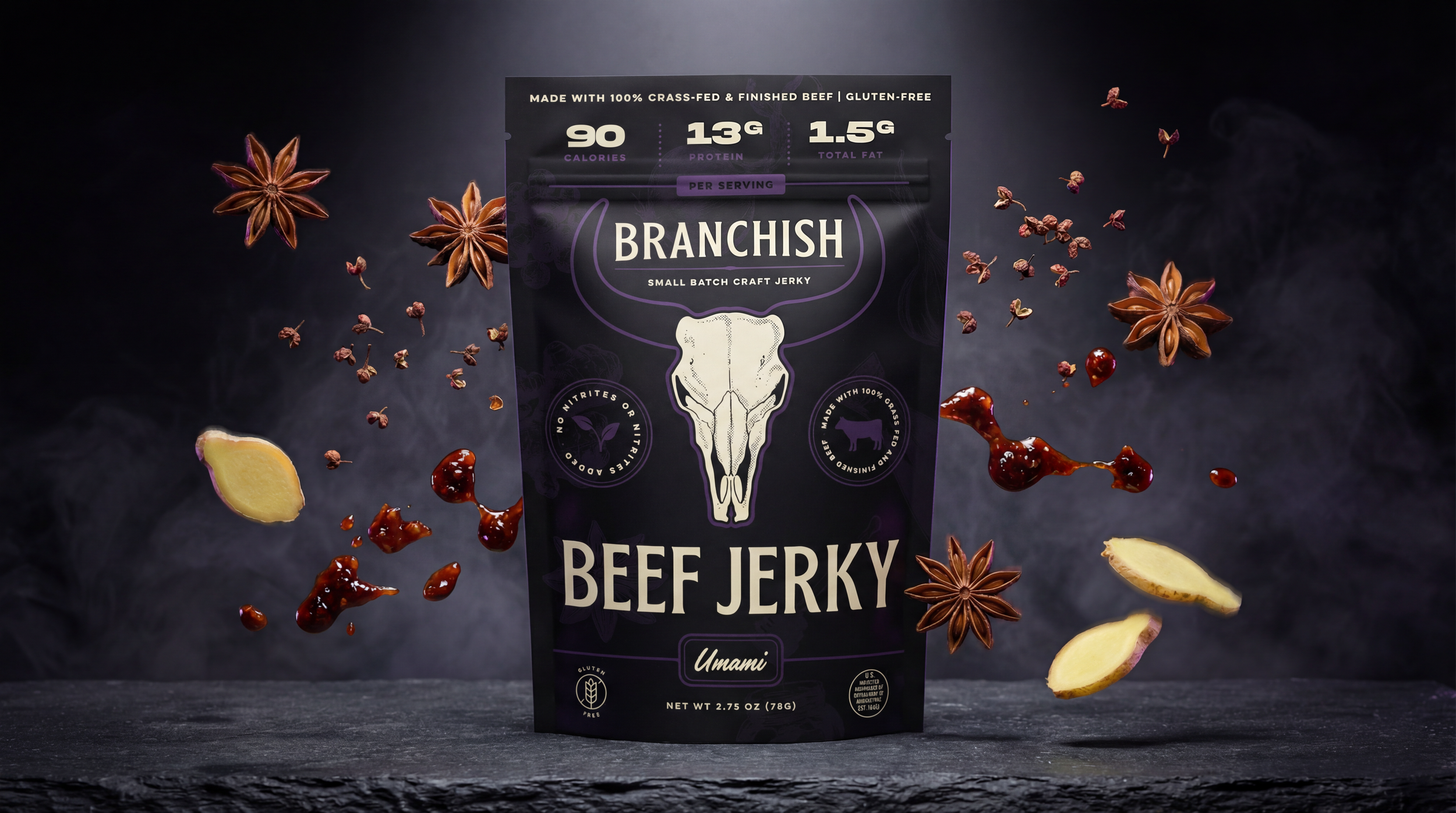 A package of Branchish beef jerky standing on a dark textured surface with floating spices, ginger slices, and red sauce surrounding it, against a dark background.