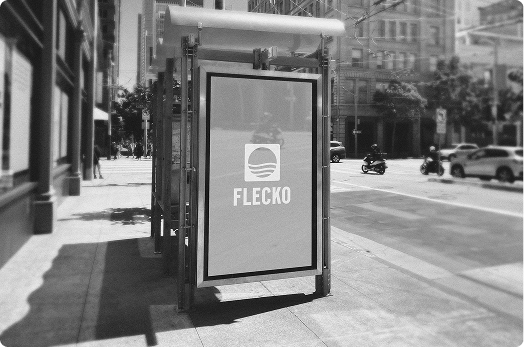 Flecko logo on a bus stop ad on a city street