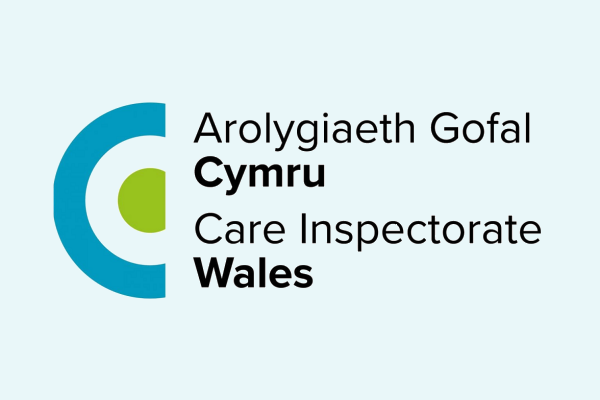 Logo of Care Inspectorate Wales with text in Welsh and English.