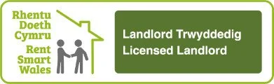 Sign with info about landlord and tenant rights, including Welsh and English text about licensed landlords and rent.