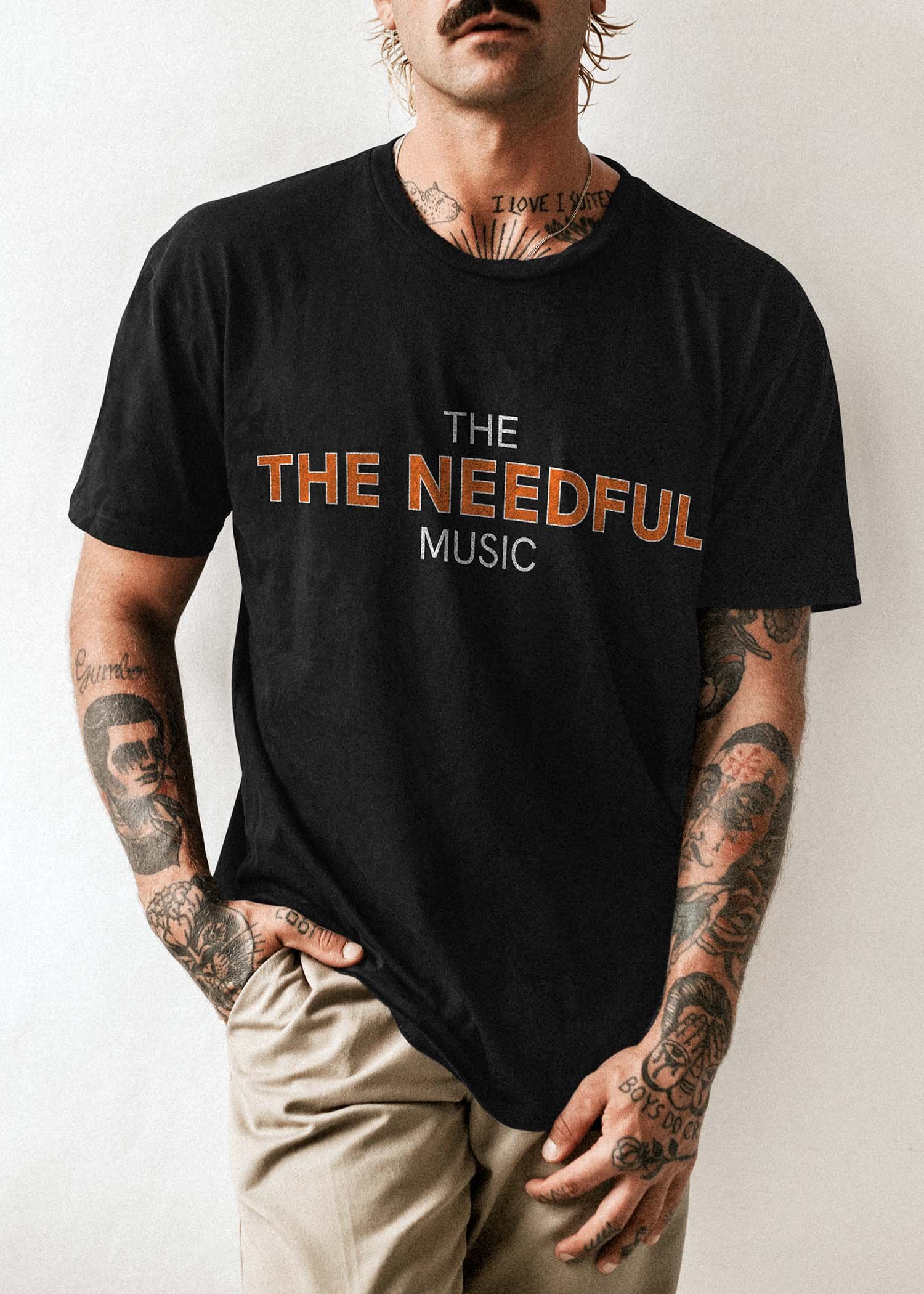 The Needful t-shirt mockup with a man with tatoos