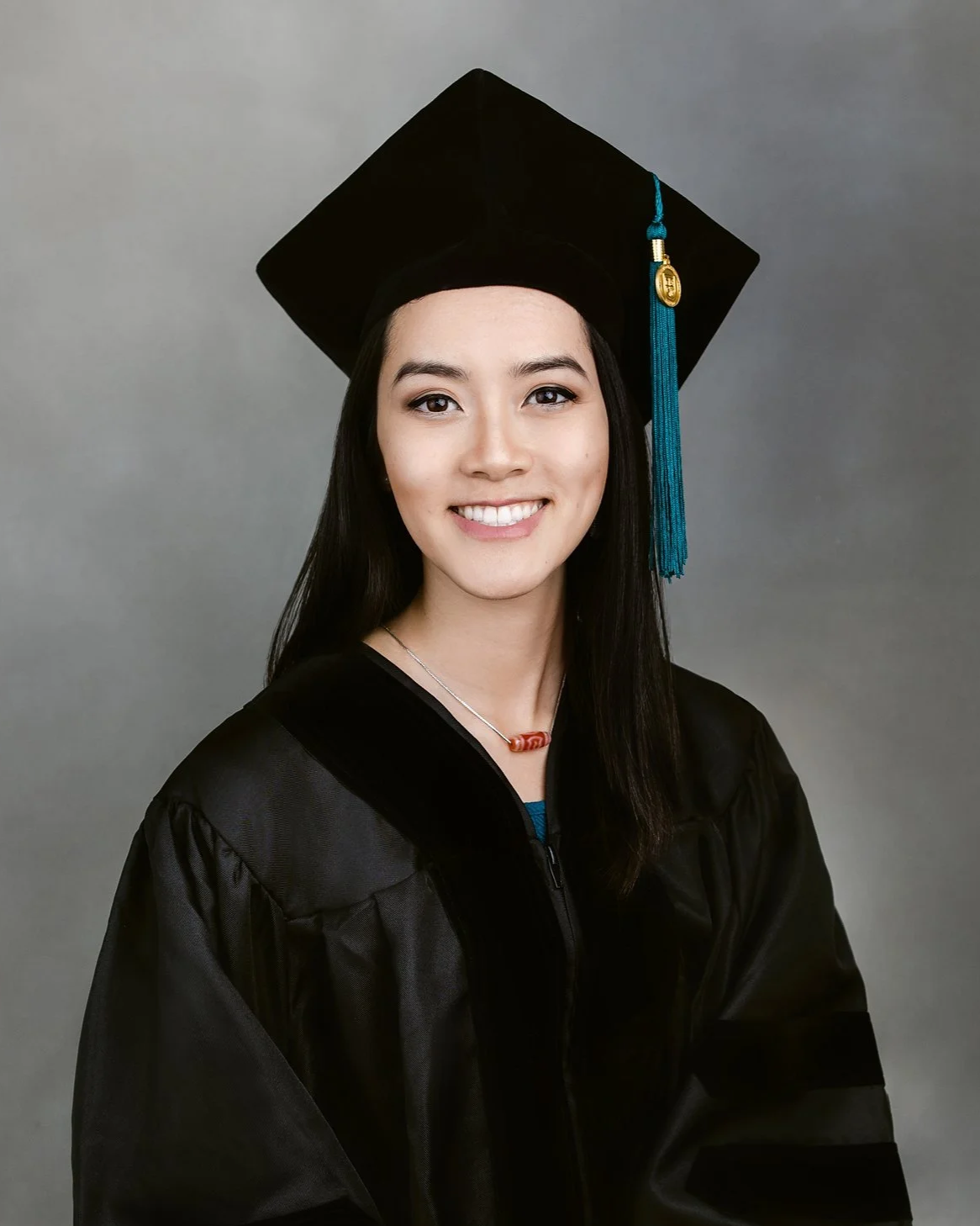 Graduation headshot with cap and gown in studio lighting at Shinkfield Studio San Marino