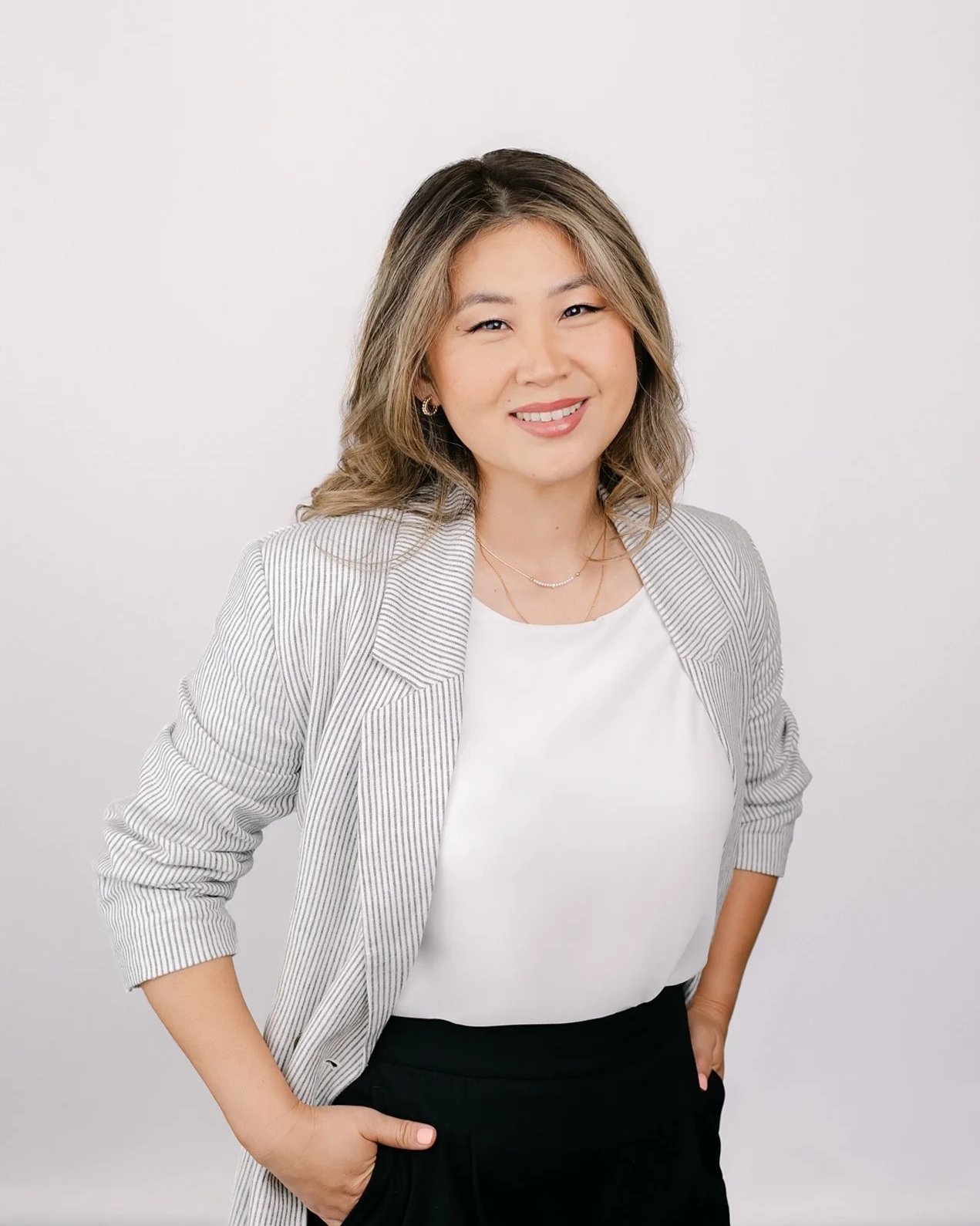 Professional headshot of a woman with a confident smile at a San Marino photography studio