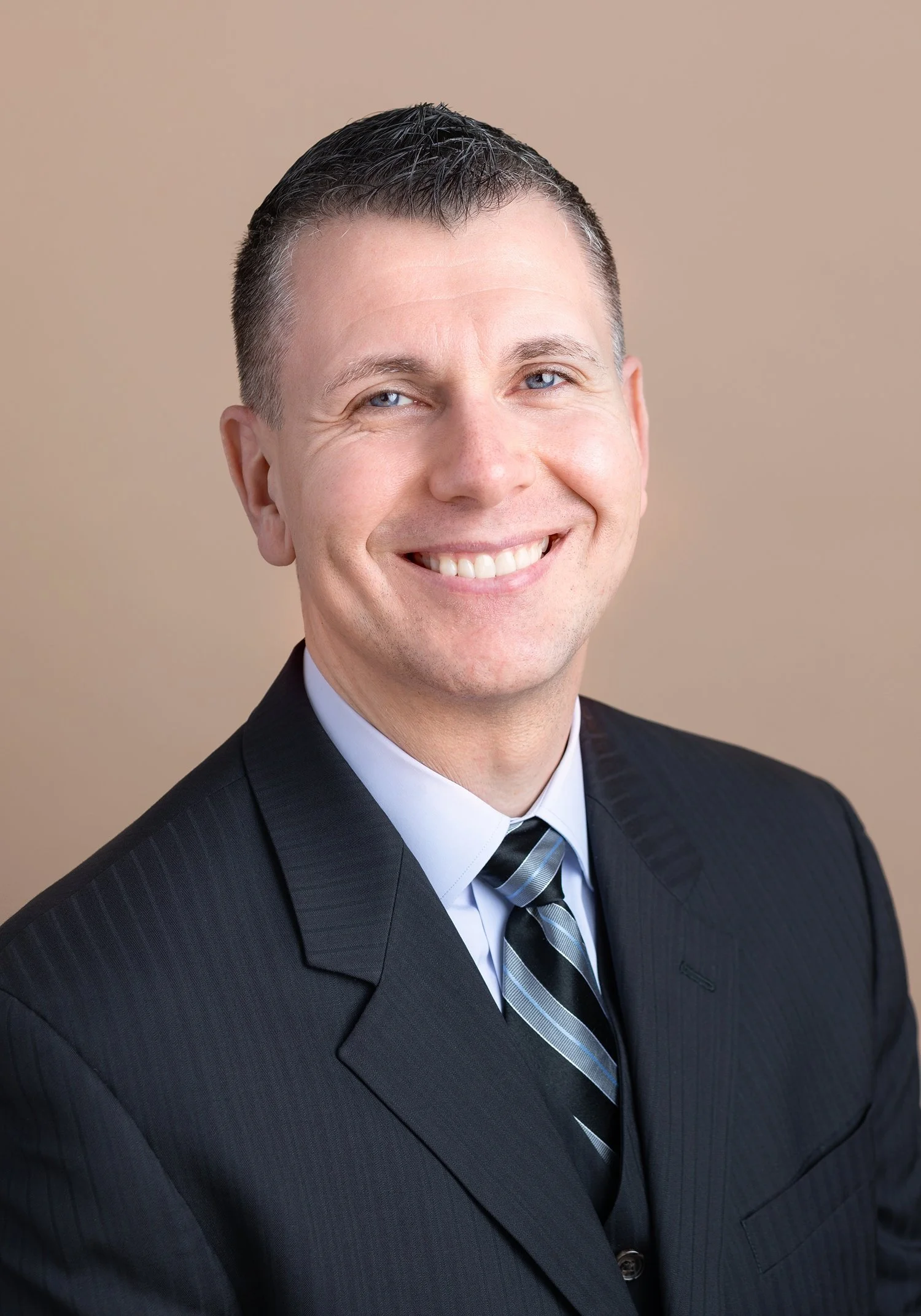 Law firm portrait of a man in a dark suit at a San Marino headshot photography studio