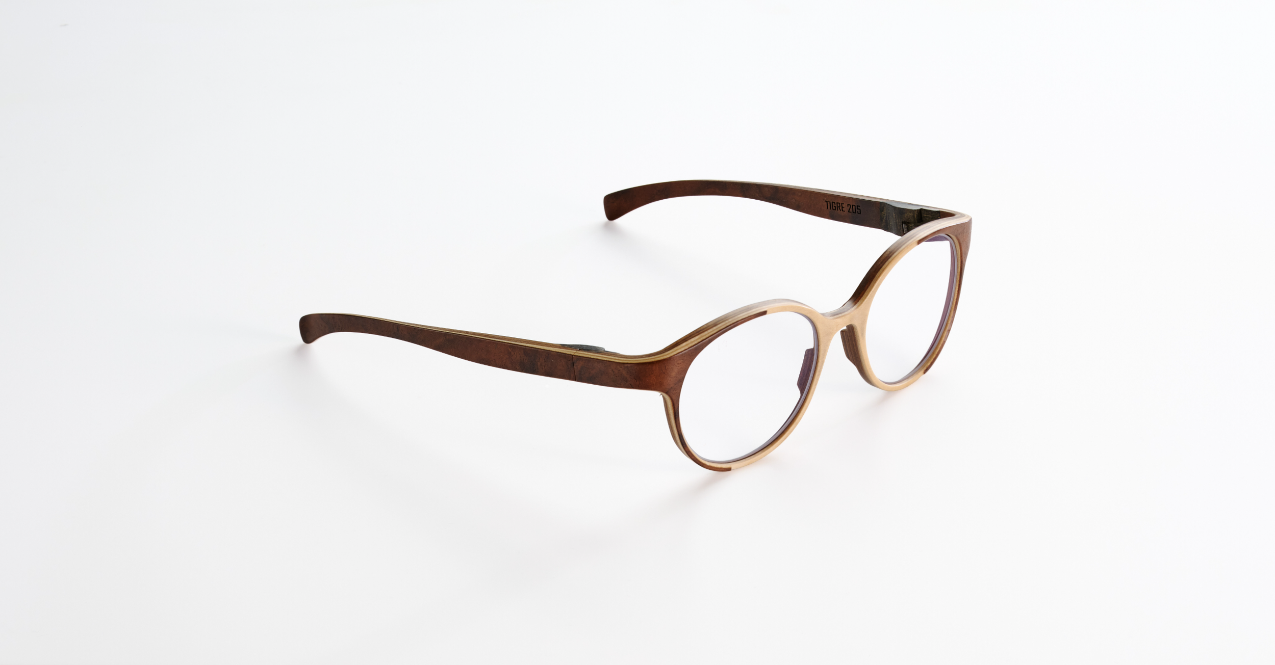 A pair of brown rounded Rolf eyeglasses with clear lenses on a white background.