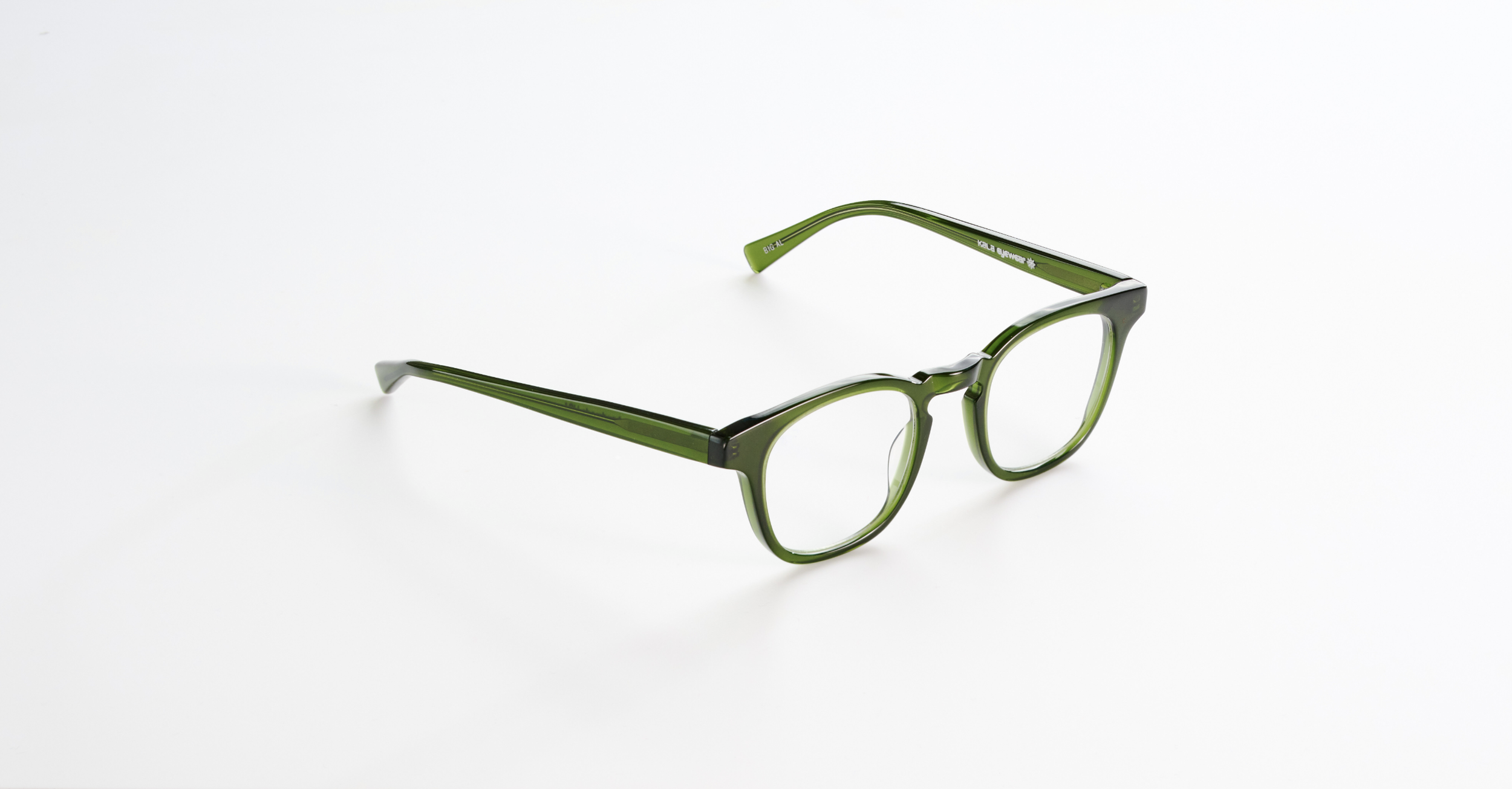 A pair of Kala Eyewear green eyeglasses with black accents on a white background.