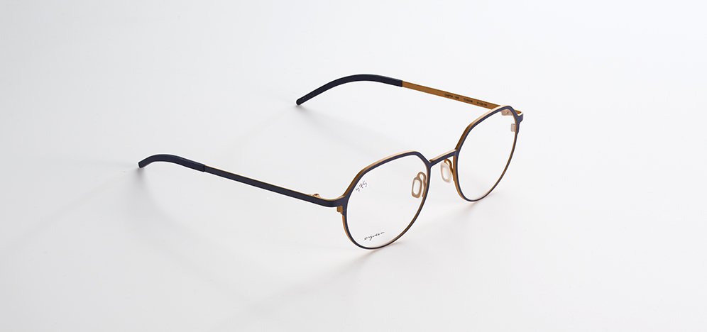 A pair of Orgreen eyeglasses with black and gold frames on a white background.