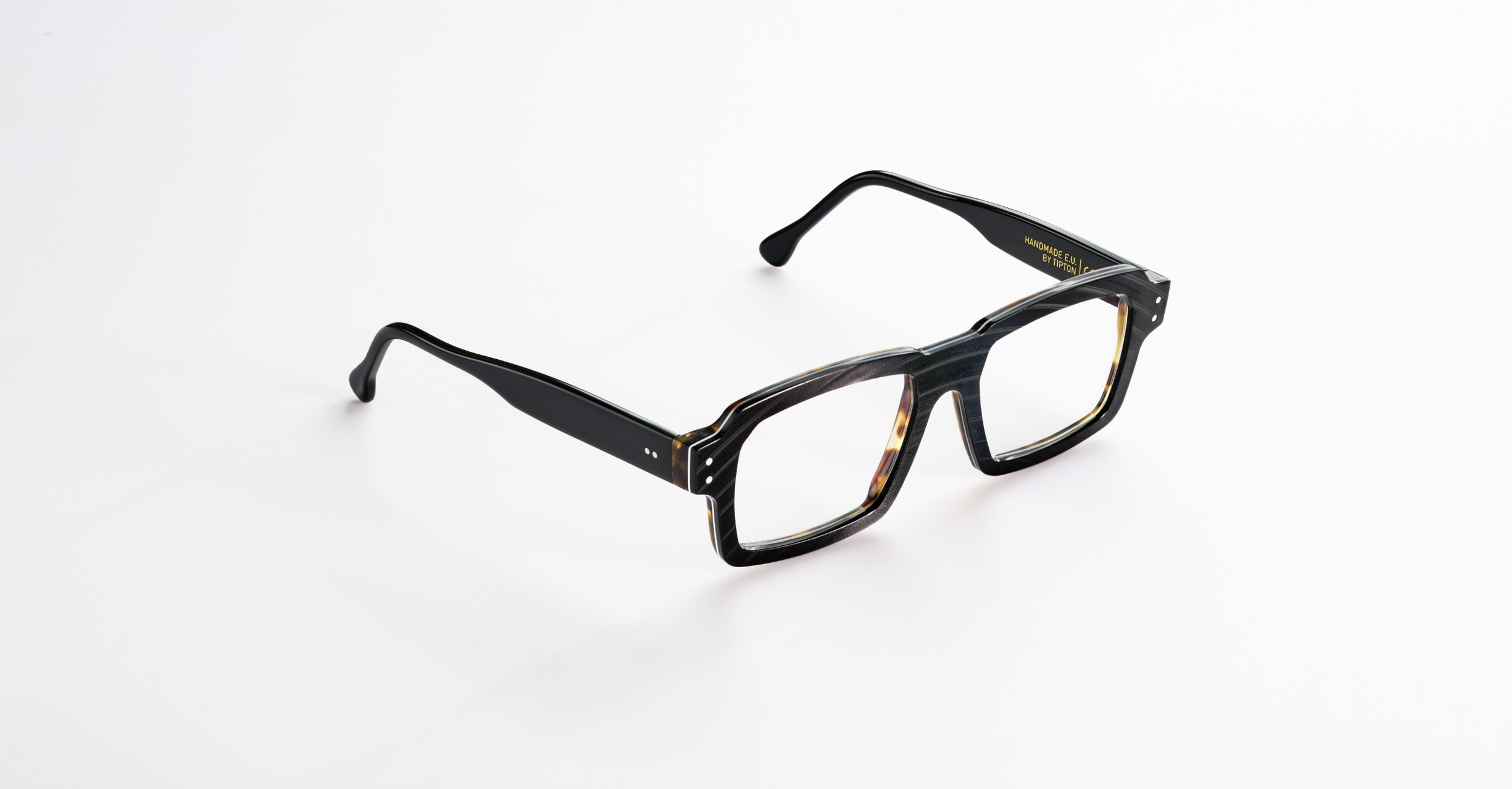 A pair of Folc black and tortoiseshell eyeglasses on a white background.
