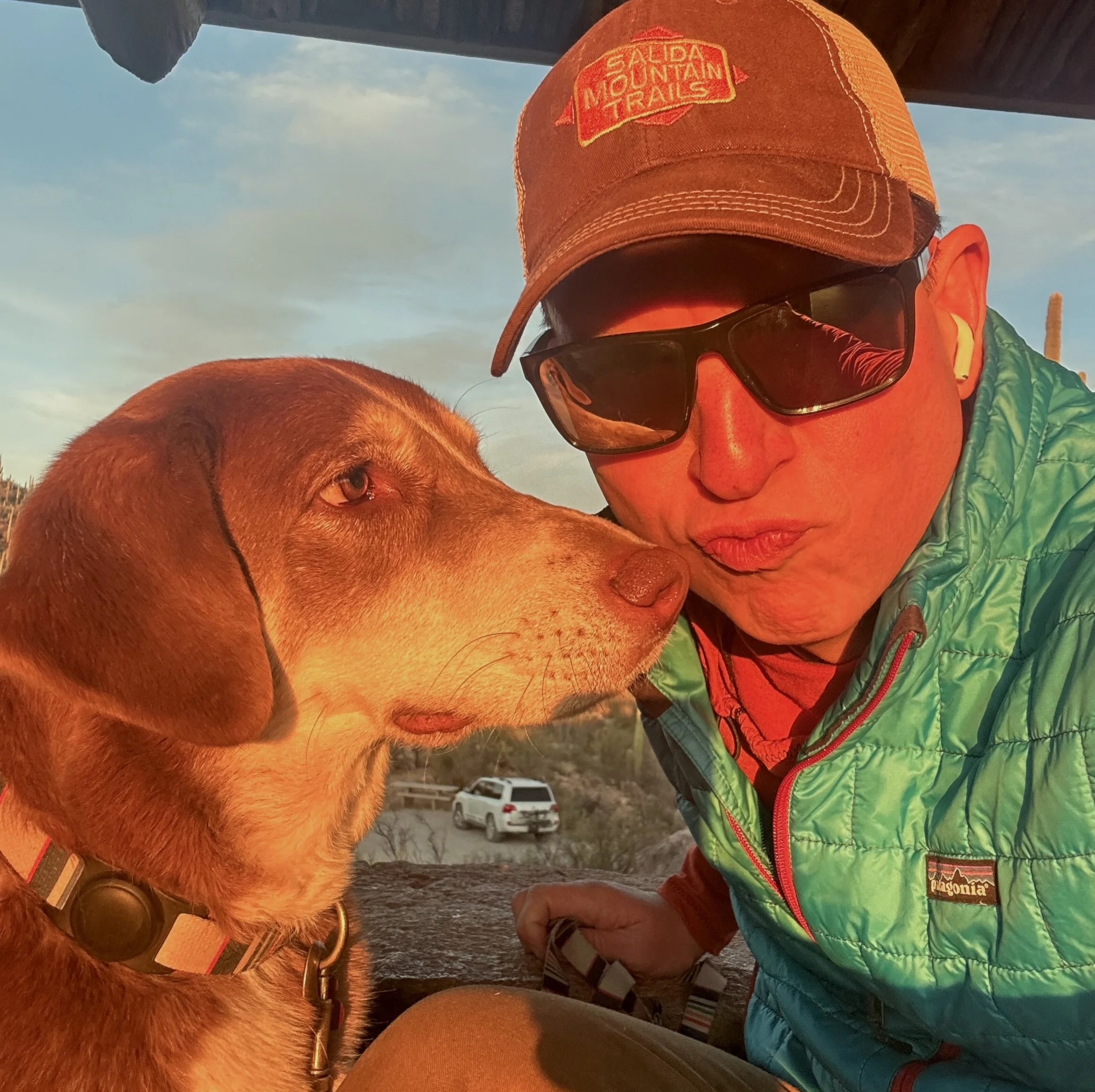 Eric and dog, Ophelia, in Saguaro NP hut at sunset