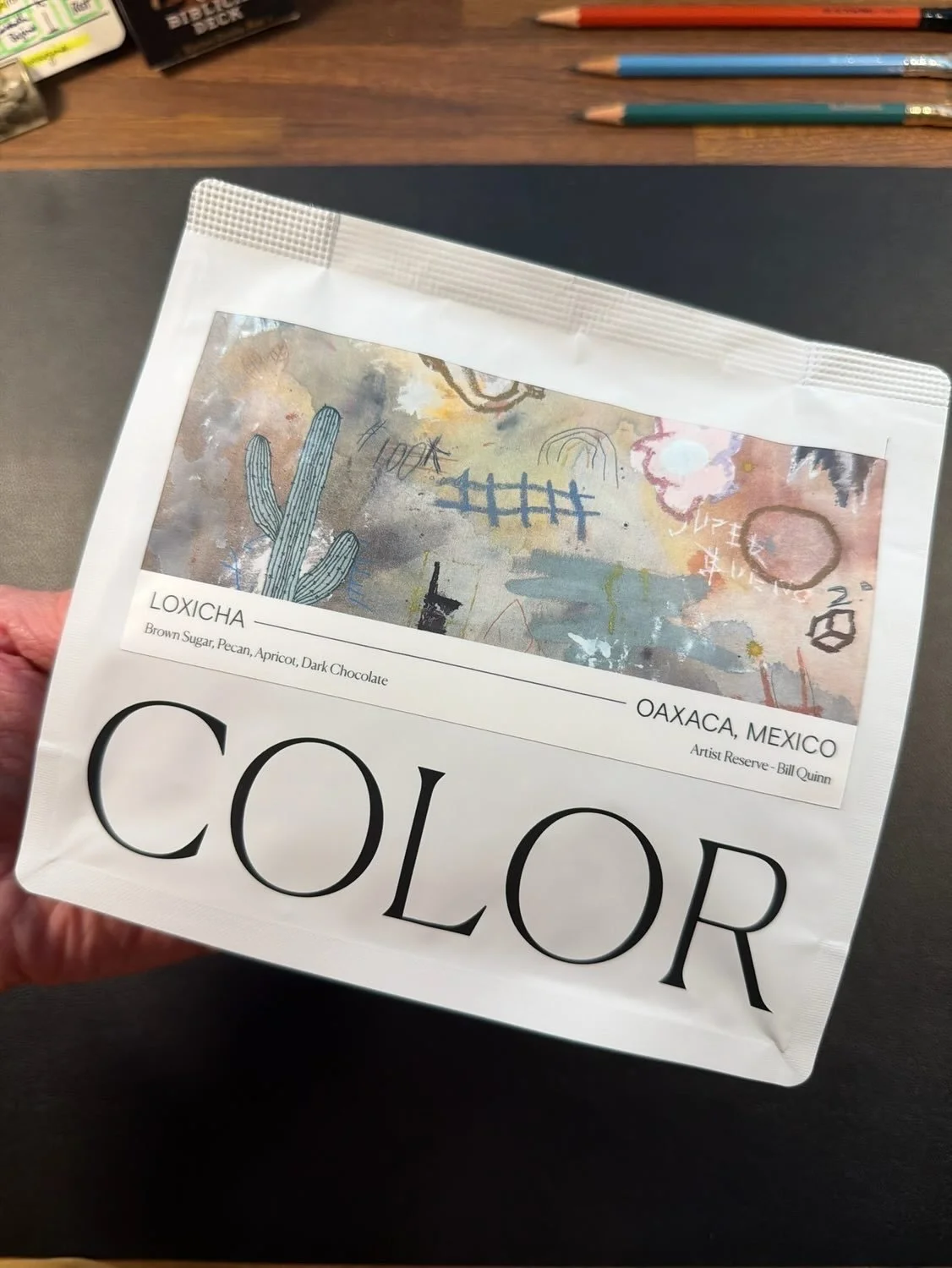 Bag of Color coffee beans with a painting from Bill Quinn