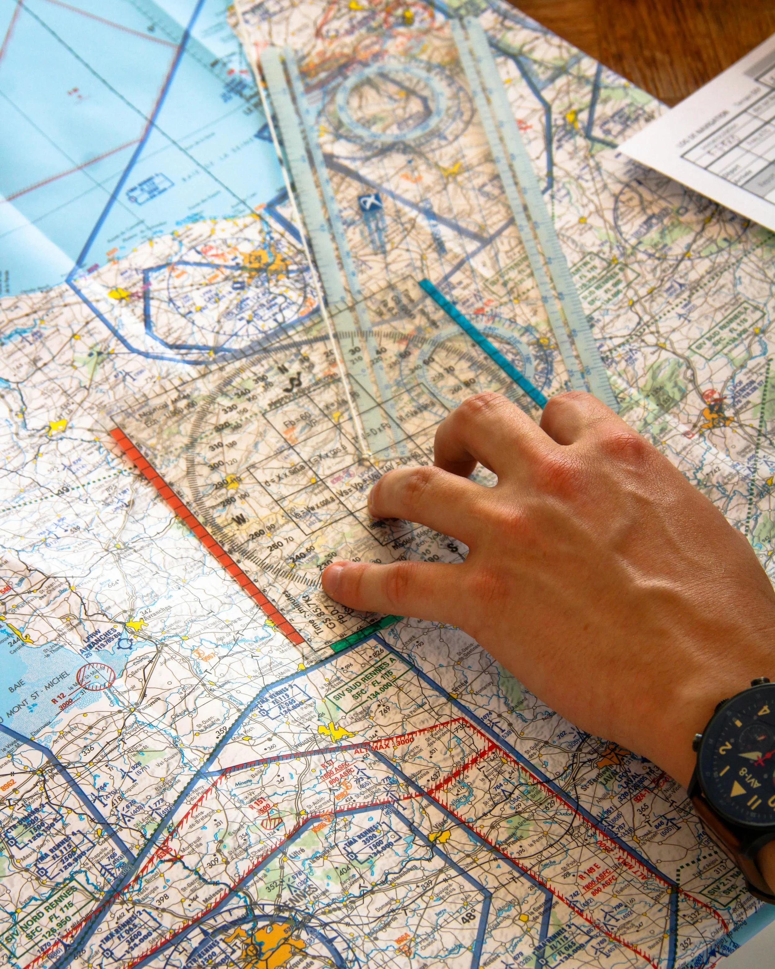 a close up of a hand carefully measuring a map