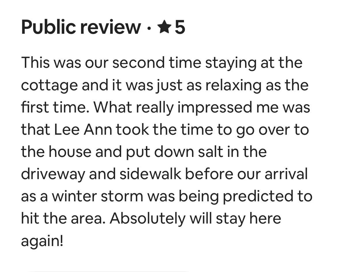 Online review with 5-star rating, praising a stay at a cottage and mentioning the host Lee Ann putting out salt before a predicted winter storm.