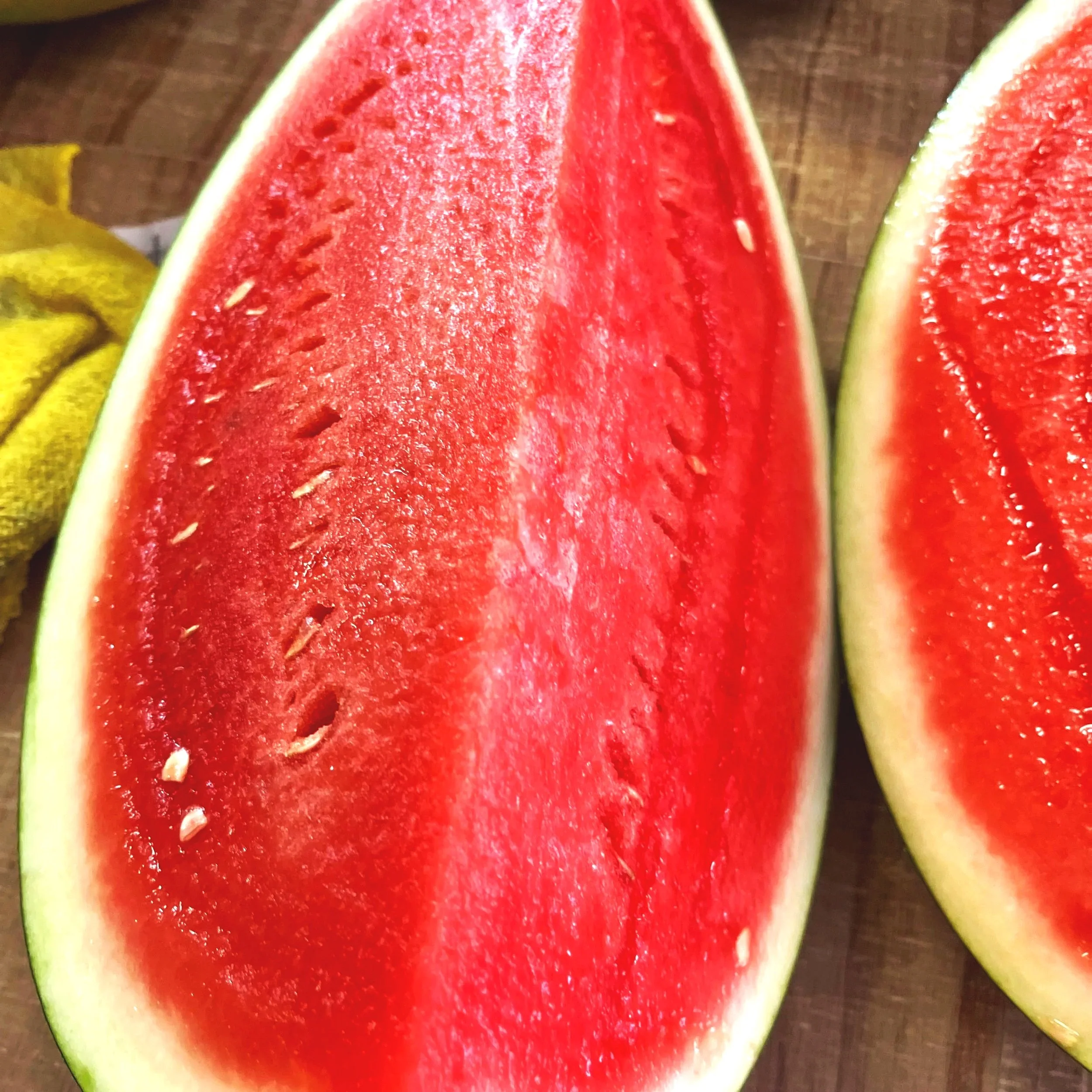 Close-up of a sliced watermelon showing red flesh and black seeds.