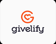 A mountain landscape with snow-capped peaks in the background, rolling green hills in the foreground, and a modern building with stone and wood walls on the hill.