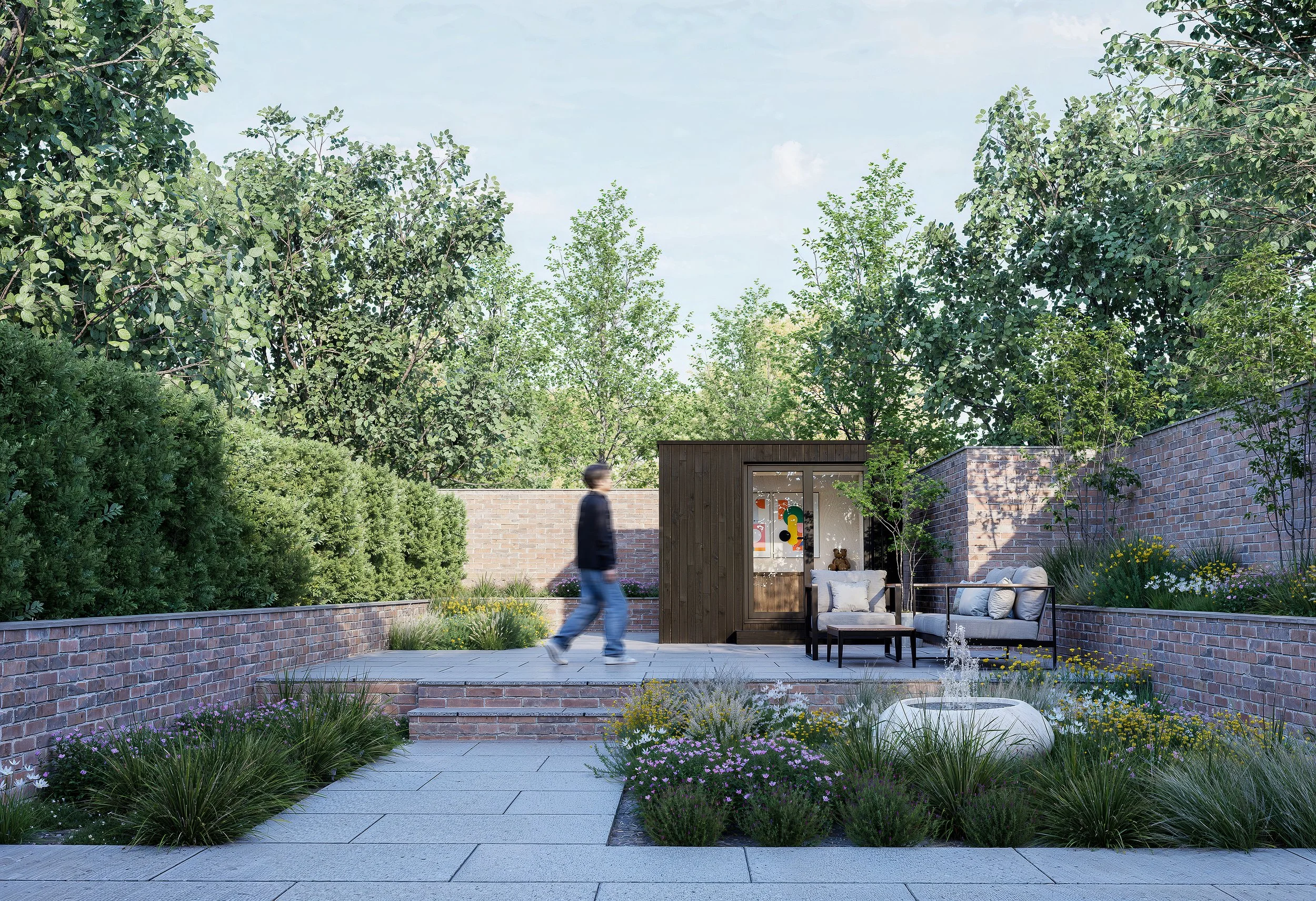 A person walking past a small outdoor seating area with chairs and a table, a tiny garden shed, and a garden with green bushes and trees, in a backyard with brick walls and a paved patio.