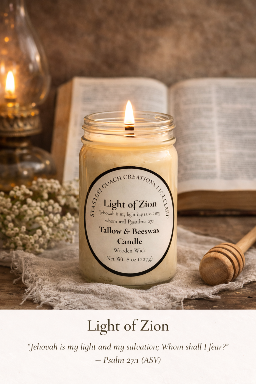 A handcrafted Light of Zion candle in a clear mason jar with a wooden wick, softly glowing on neutral linen fabric in warm natural sunlight. The cream label reads “Light of Zion” with Psalm 27:1.