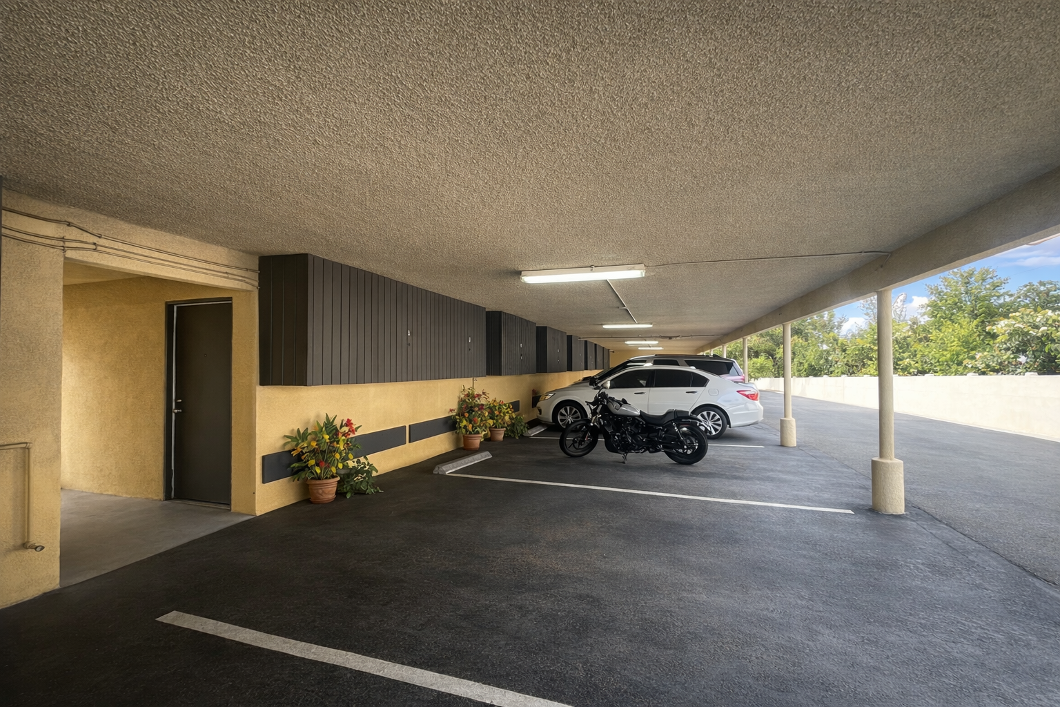 Covered parking at Palm Vista with locked additional storage boxes.
