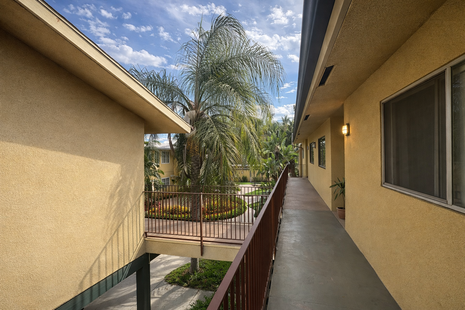 Walkways on second floor of Palm Vista Apartment Homes with mountain views 