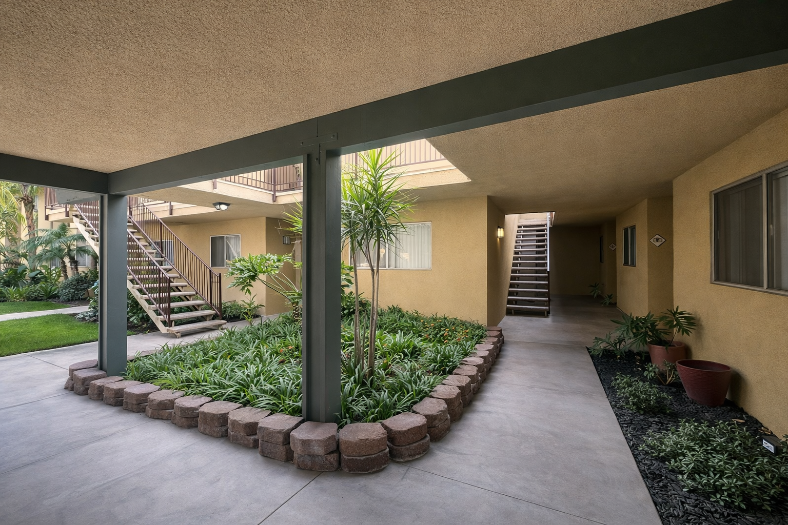 Interior Courtyard at Palm Vista surrounded by Lush greenery and mountain views. 
