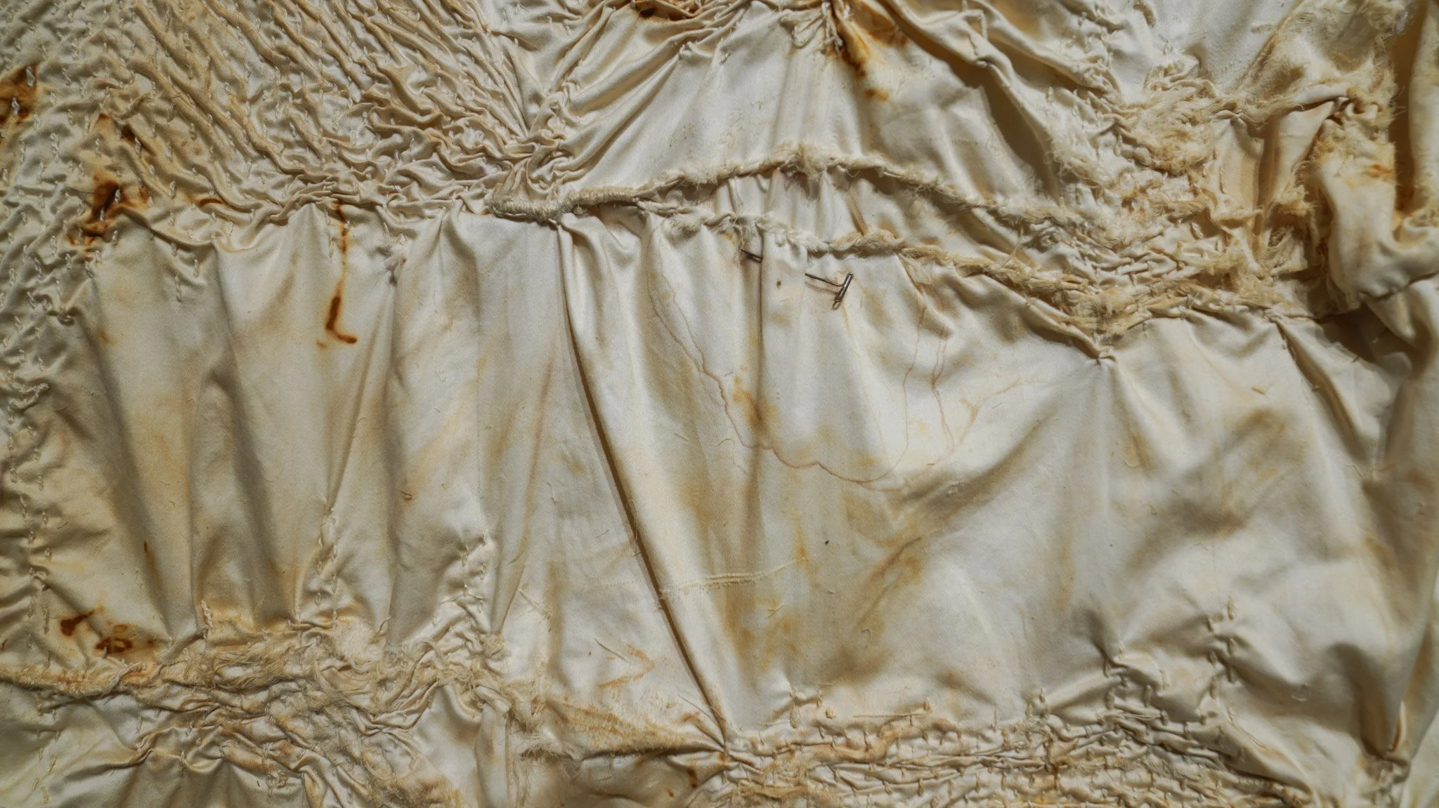 Close-up of a wrinkled, stained, and crumpled piece of parchment or paper.