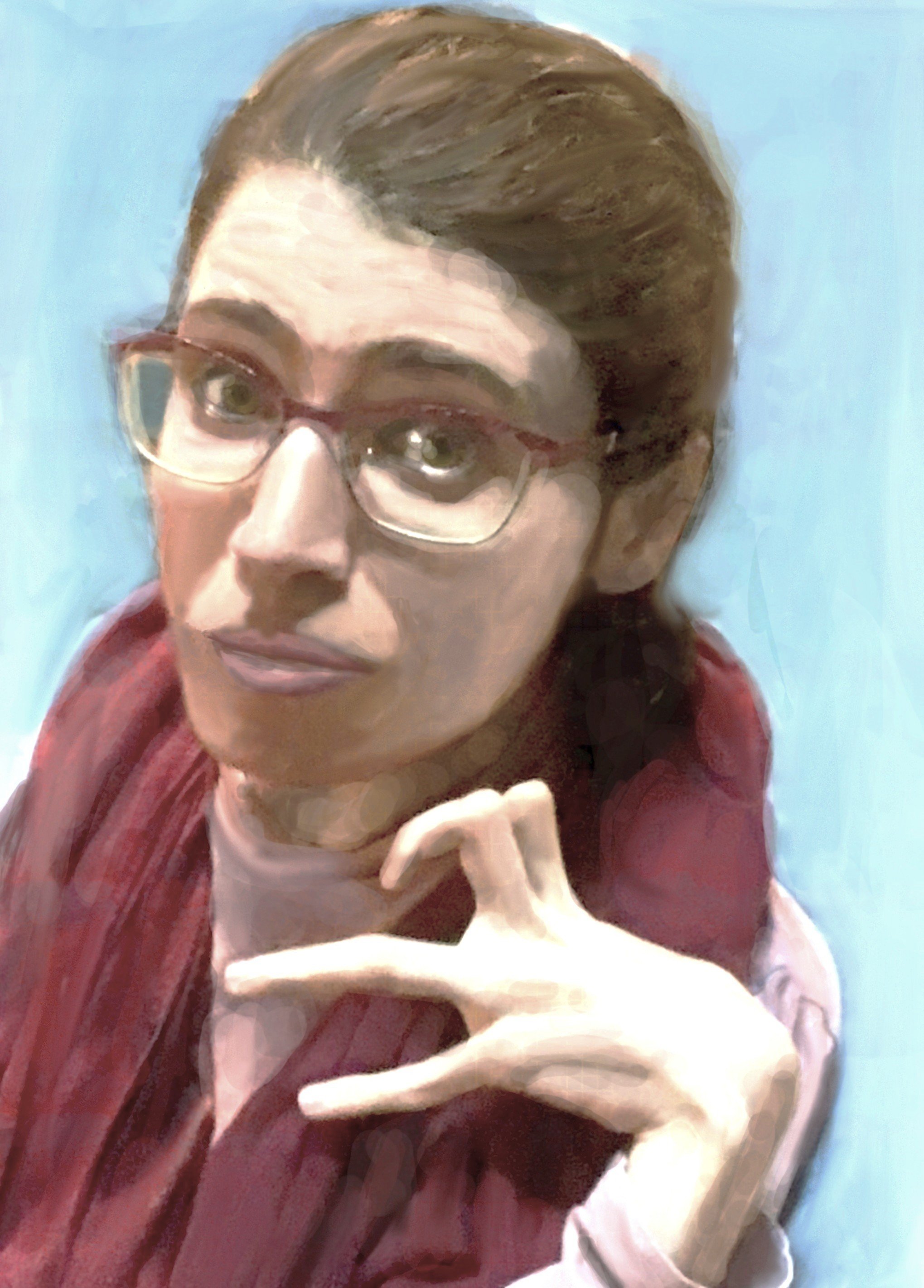 A woman with glasses, short brown hair, wearing a maroon jacket and a light pink shirt, making a hand gesture in front of a light blue background.