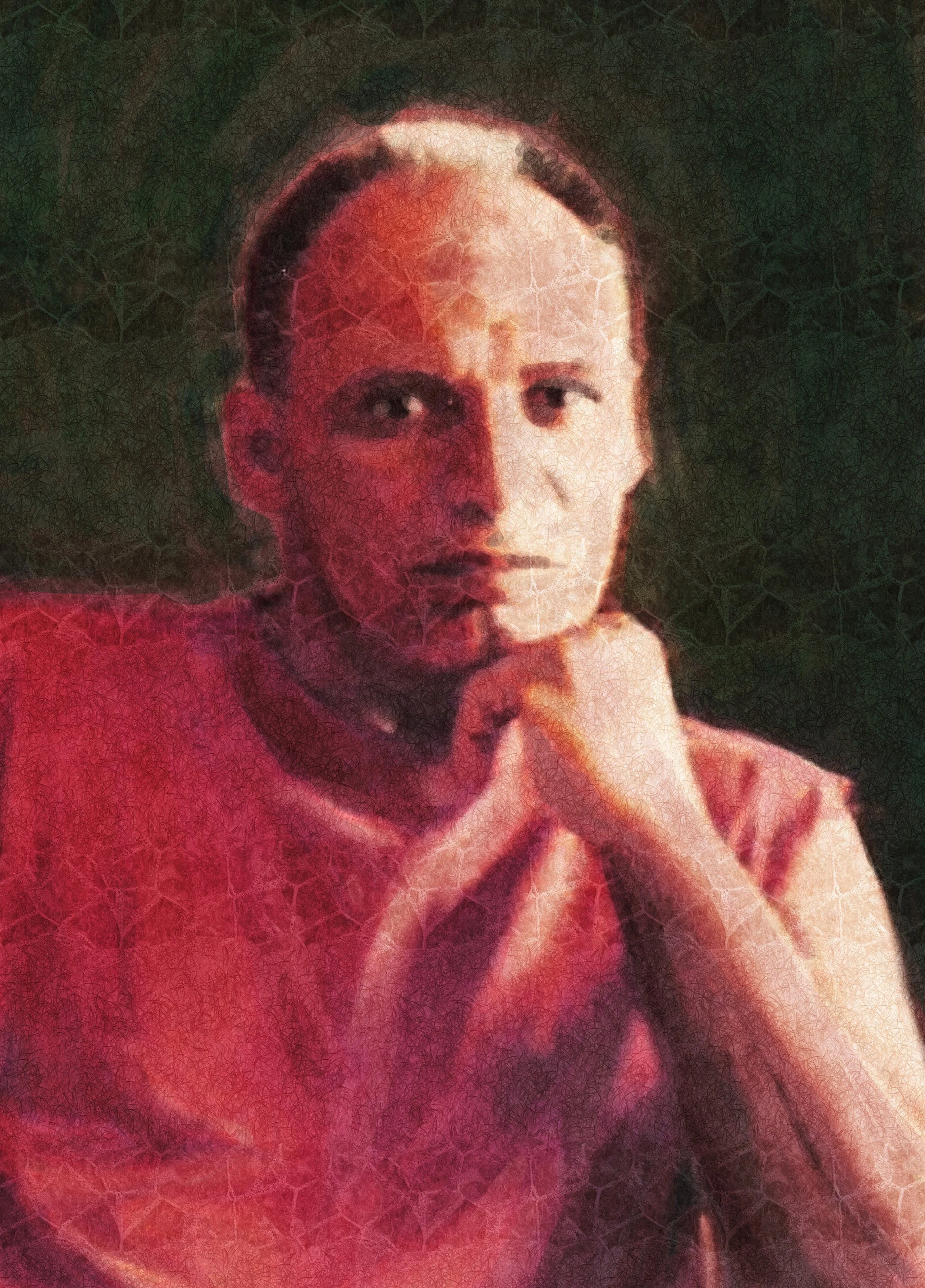 A man with a serious expression resting his chin on his hands, wearing a red top, with a dark and green background.