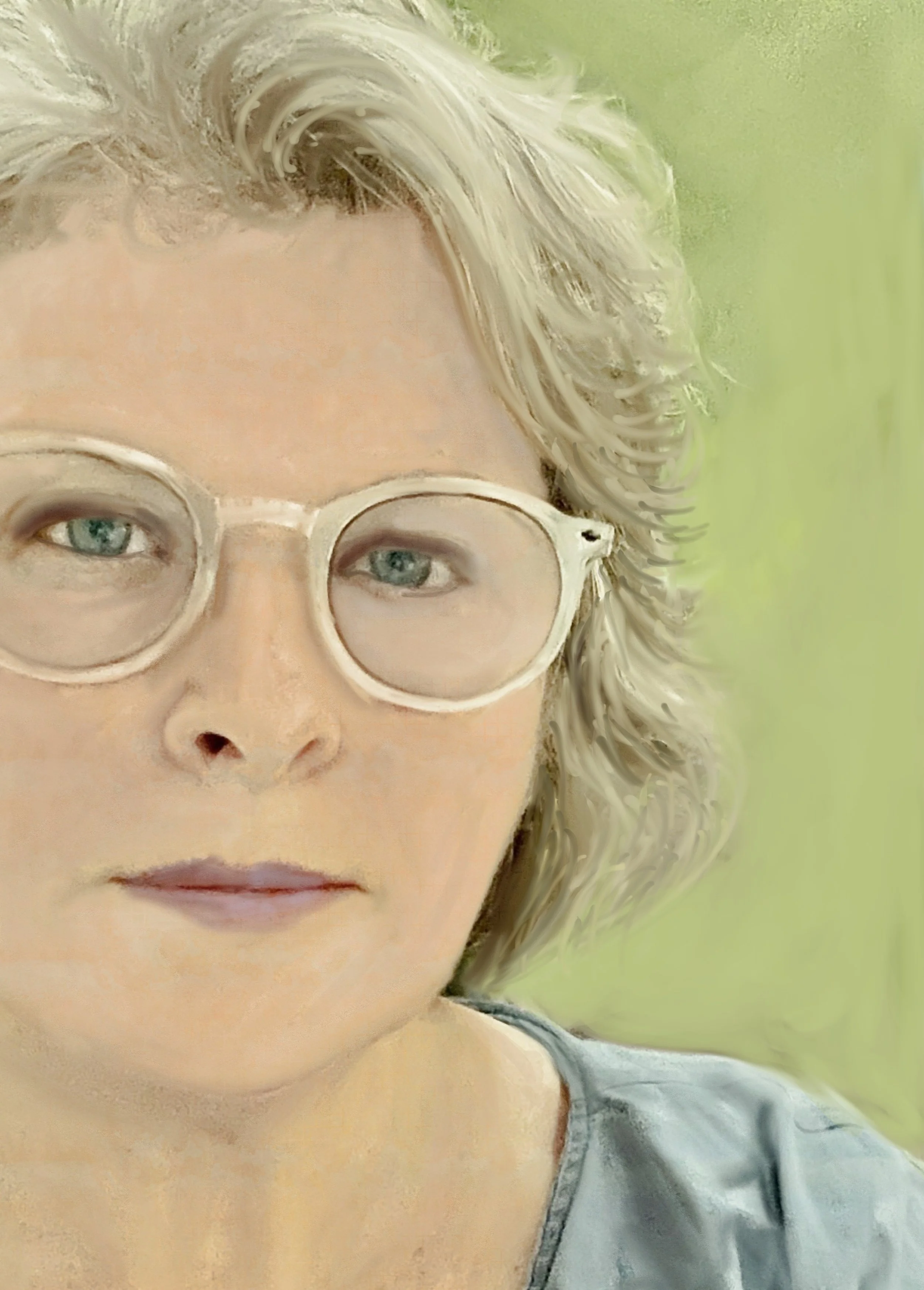 A woman with blonde wavy hair wearing round glasses with a light-colored frame, a neutral expression, and a light gray shirt, outdoors with a blurred green background.
