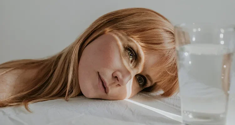 Pster image of actor Michelle Blundell for theatre production Pool No Water at Basement Theatre. Michelle is staring into a glass of water