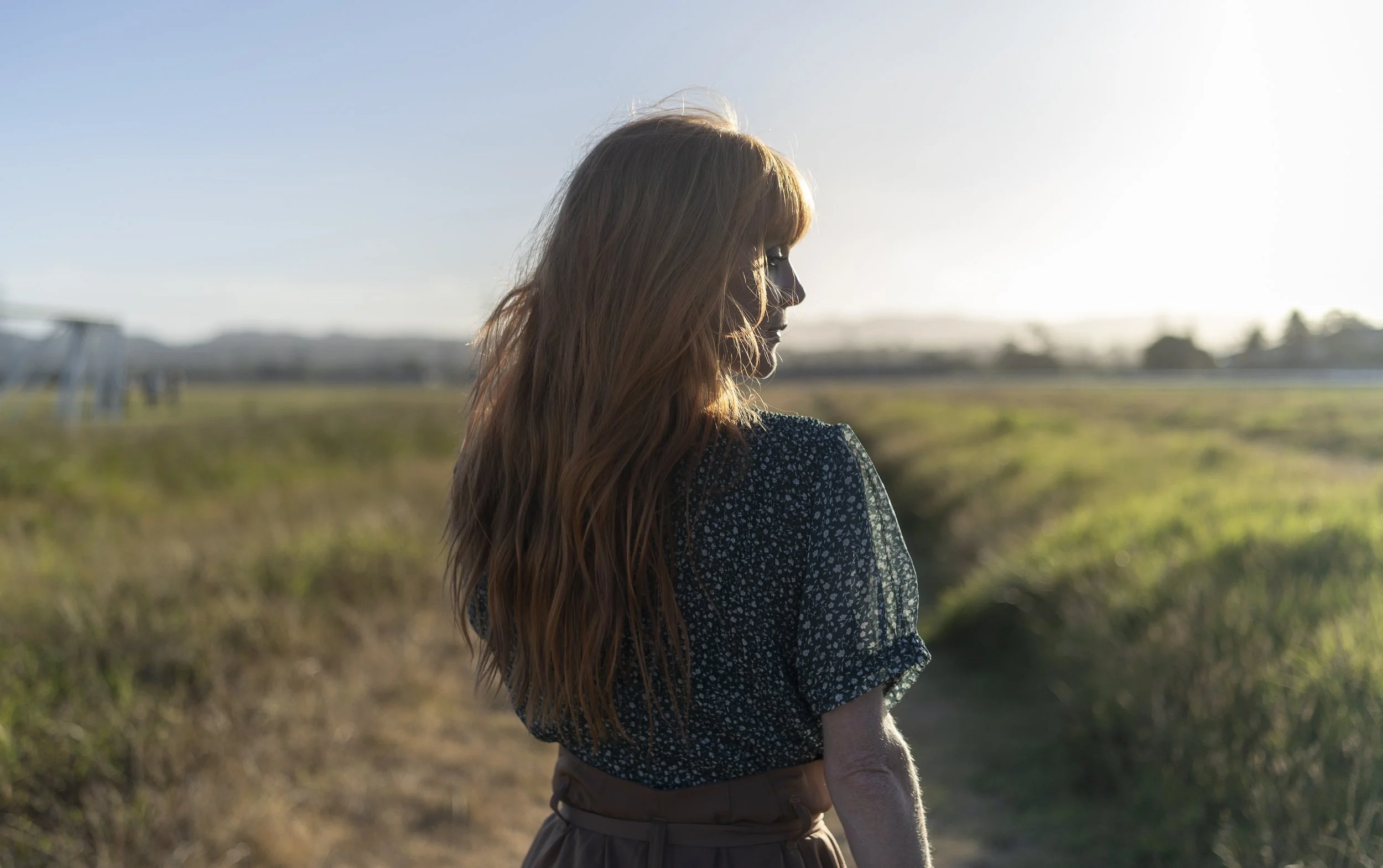 Michelle Blundell photographed from the back as she walks on a field