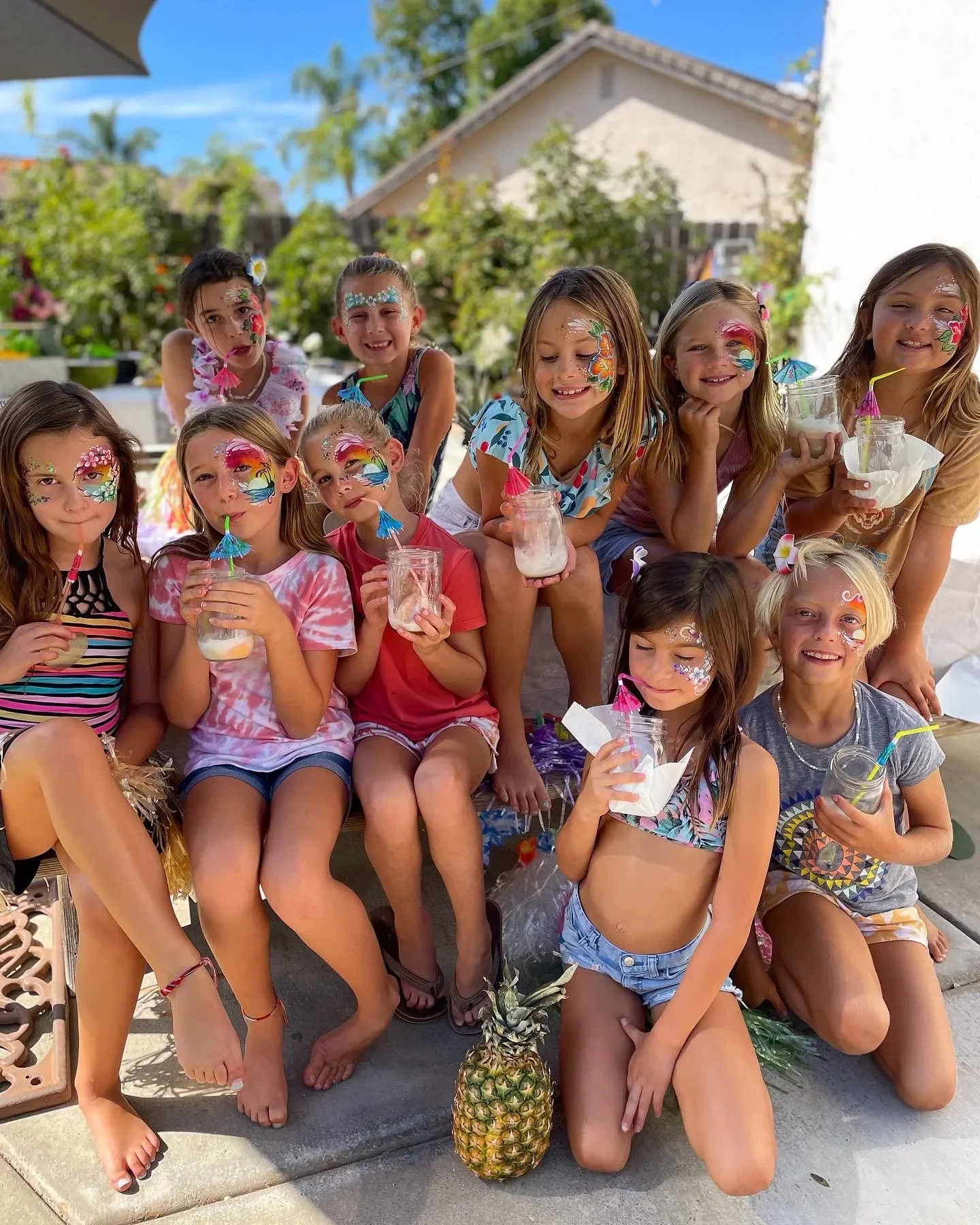 Children with colorful face painting designs at a birthday party by Happy Cat Entertainment