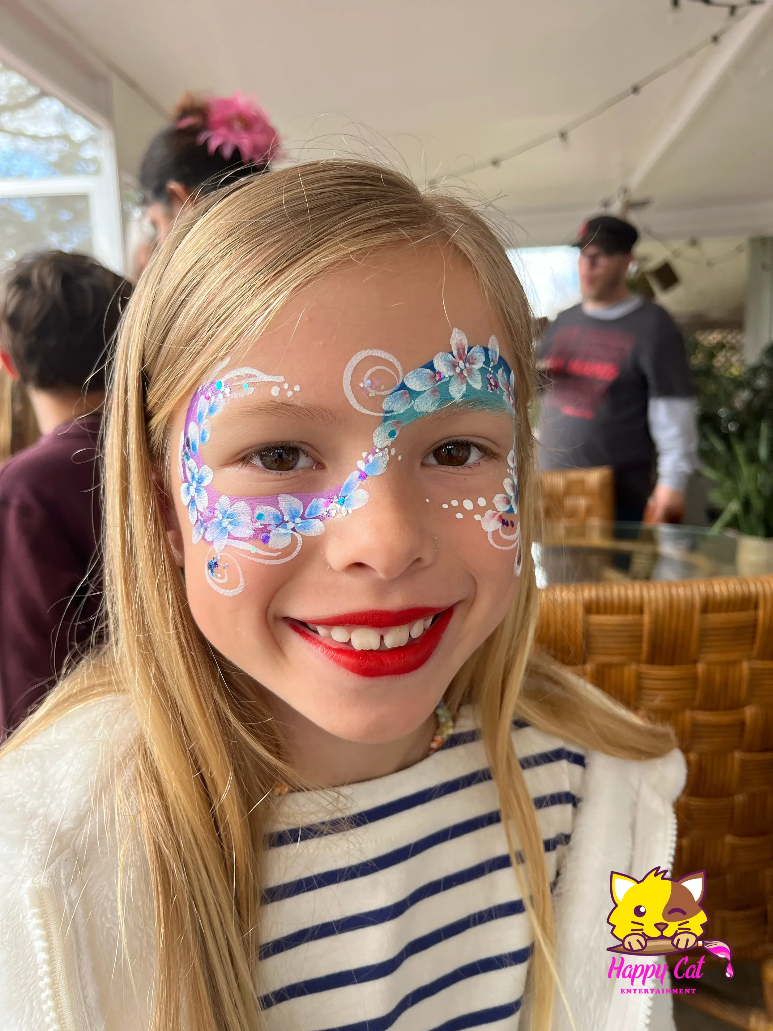 Young girl with flower eye face paint design by Happy Cat Entertainment in San Diego, California.