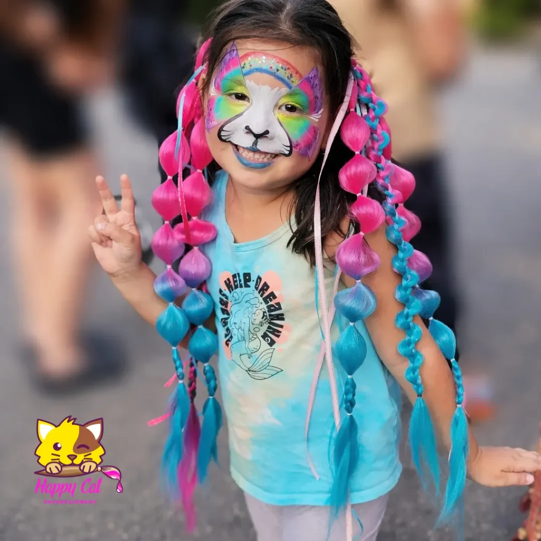 Excited young birthday girl with rainbow bubble braids and rainbow cat face paint at a Happy Cat Entertainment party in Temecula California.