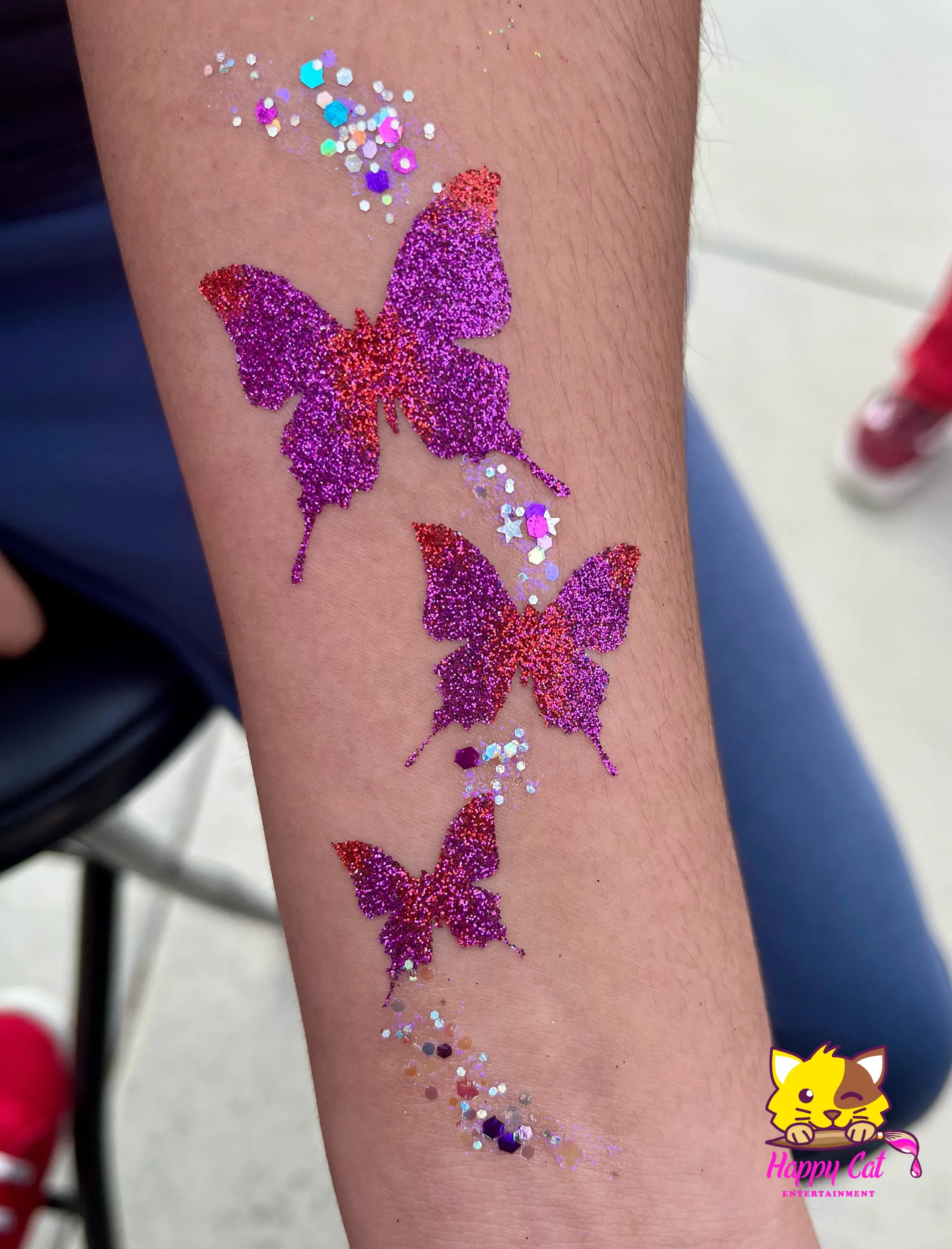 Young girl with a glitter butterfly tattoo by Happy Cat Entertainment in Temecula and San Diego, California