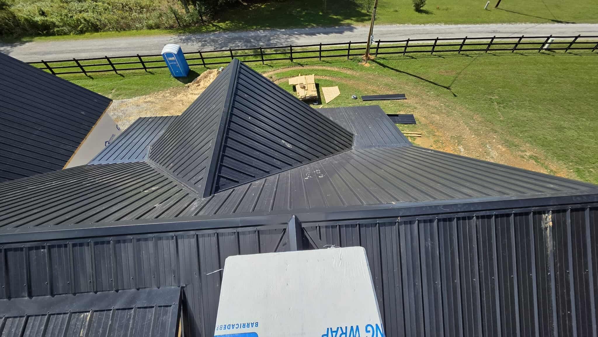 dark standing seam metal roof on residential home by Dorian Roofing McMinnville TN