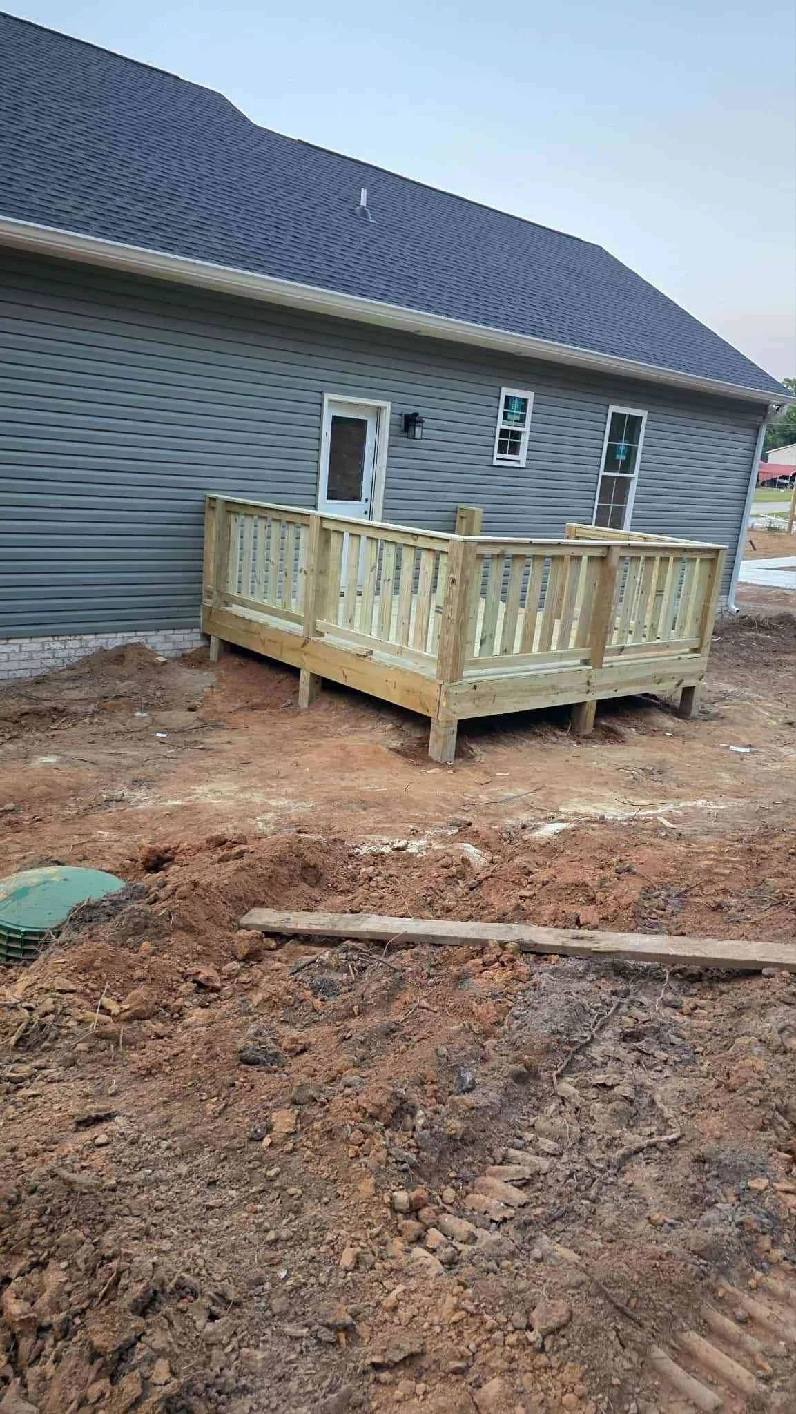 back of home with new wood deck and fresh grading and Construction in McMinnville TN