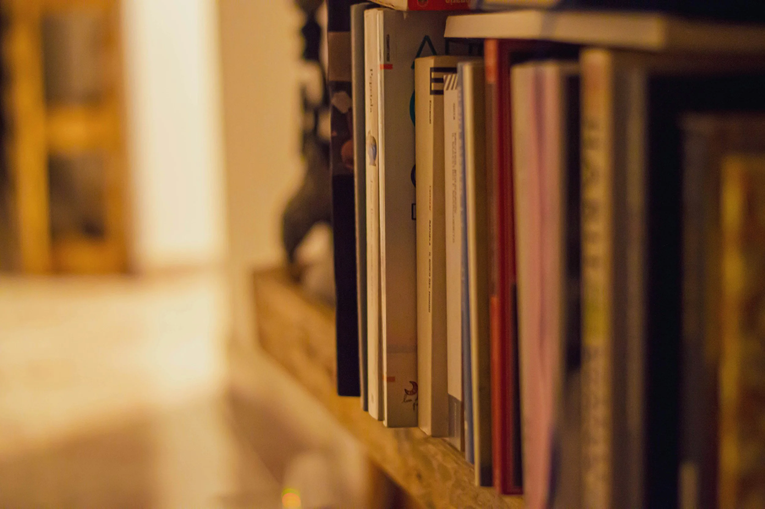 Close-up of a wooden bookshelf filled with various books.