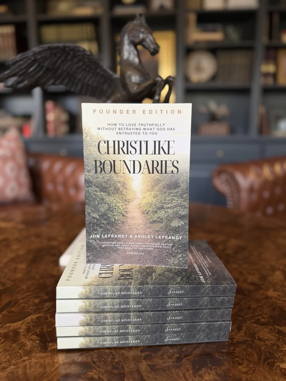 Stack of Christlike Boundaries Founder Edition paperbacks by Jon and Ashley Lefrandt