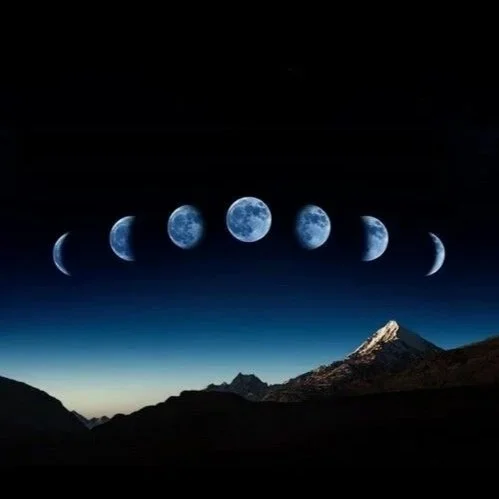 A series of lunar phases arranged in an arc above a mountain landscape at night.