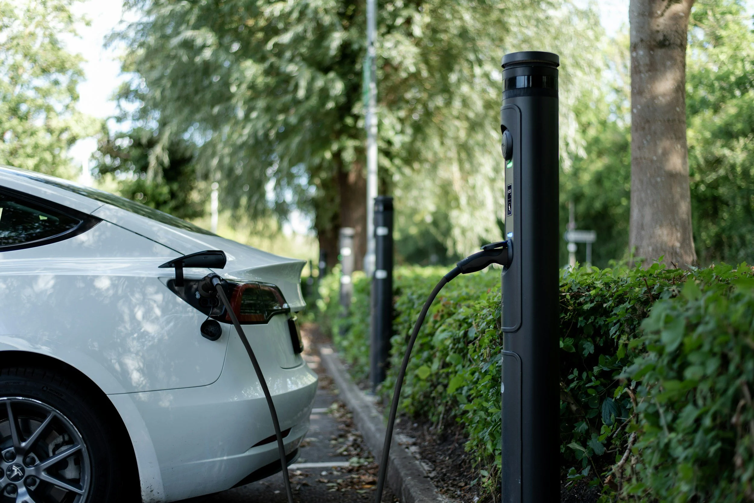 EV charger cable plugged into an electric car at a residential charging location