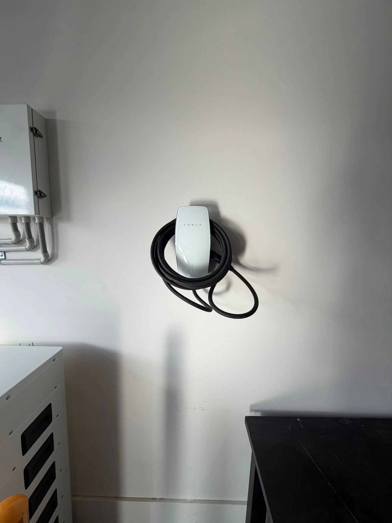 Customer-supplied Tesla Wall Connector installed on garage wall in Hoppers Crossing