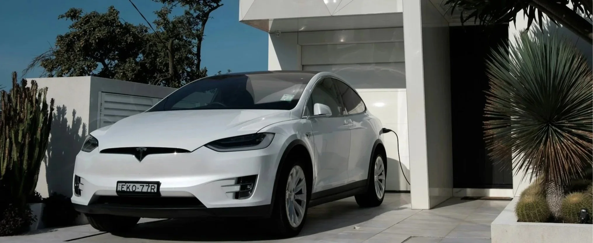 Tesla electric vehicle charging at home, representing residential EV charger installation by Aether Installations.