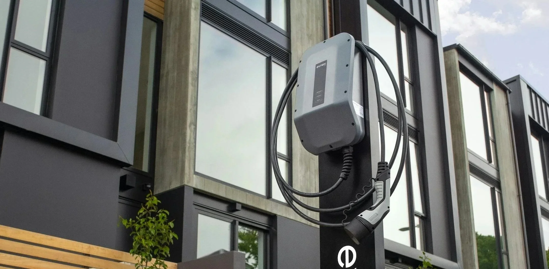 Wall-mounted EVNEX EV charger on a modern home exterior, representing residential EV charger installation.
