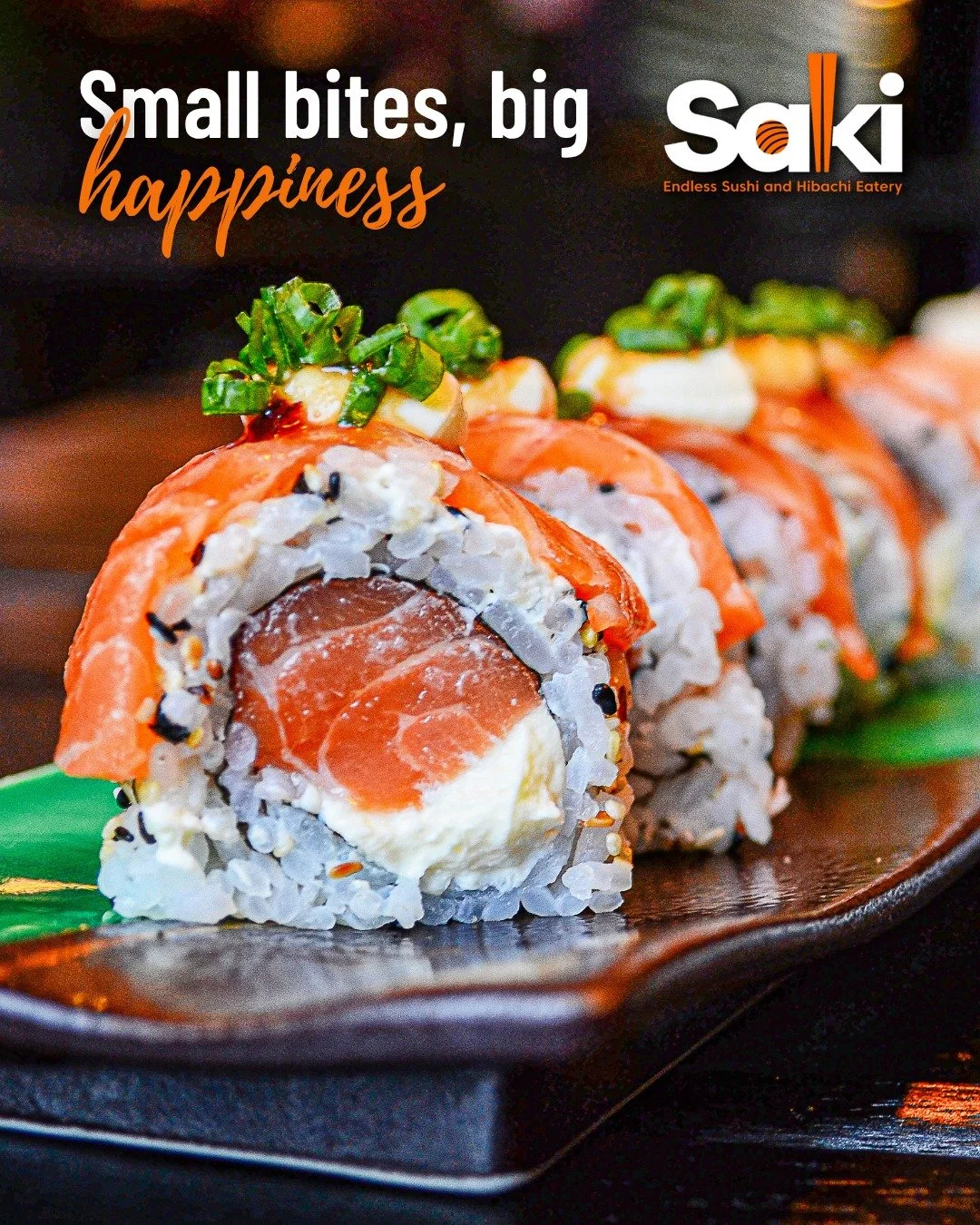 Close-up of a sushi roll with salmon, cream cheese, and green onion on a black plate, with text "Small bites, big happiness" and a restaurant logo in the top right corner.