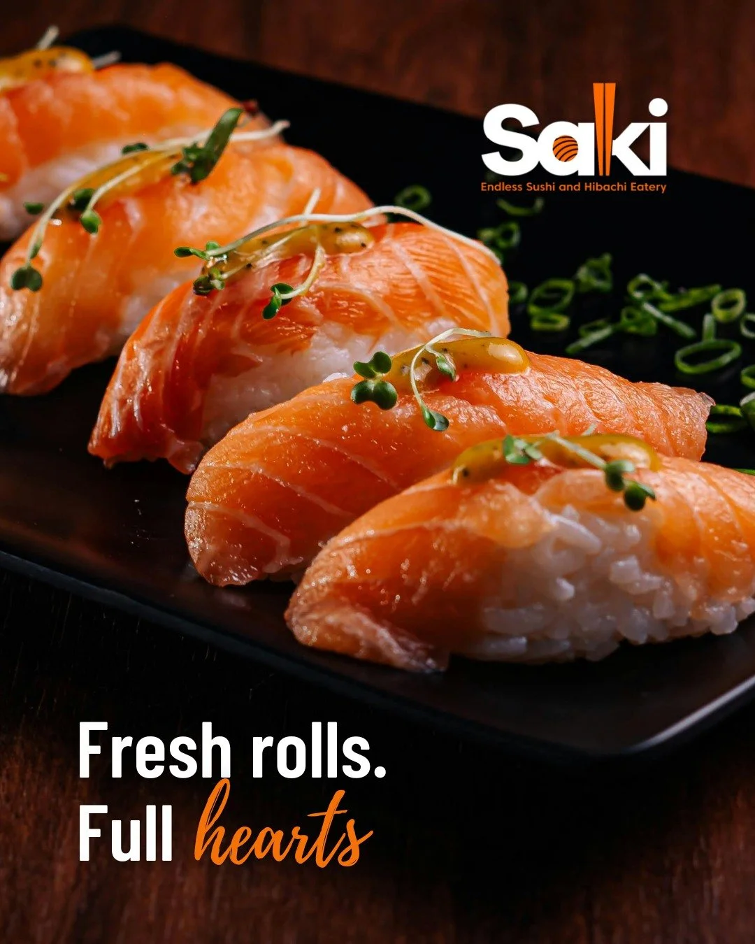 A close-up of fresh salmon sushi rolls garnished with microgreens on a black plate, with green onion slices in the background, and the text "Fresh rolls. Full hearts" alongside a logo for Saki, an eatery specializing in sushi and hibachi.