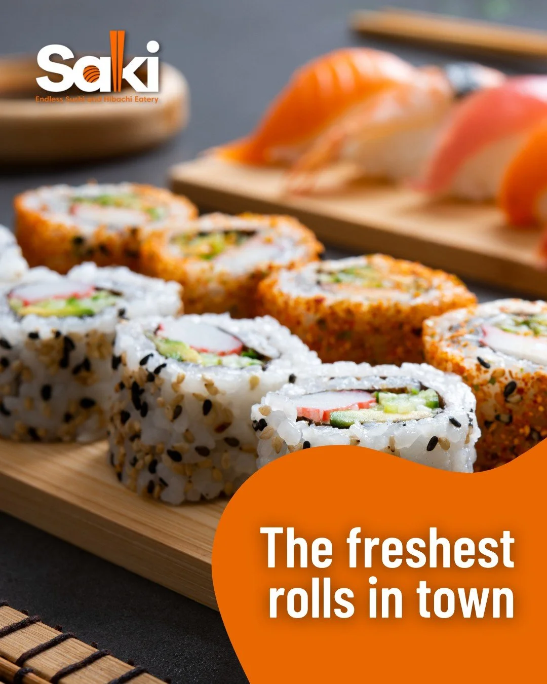 Close-up of assorted sushi rolls on a wooden platter with a blurred background of sashimi. The Saki logo and orange text overlay say 'The freshest rolls in town'.