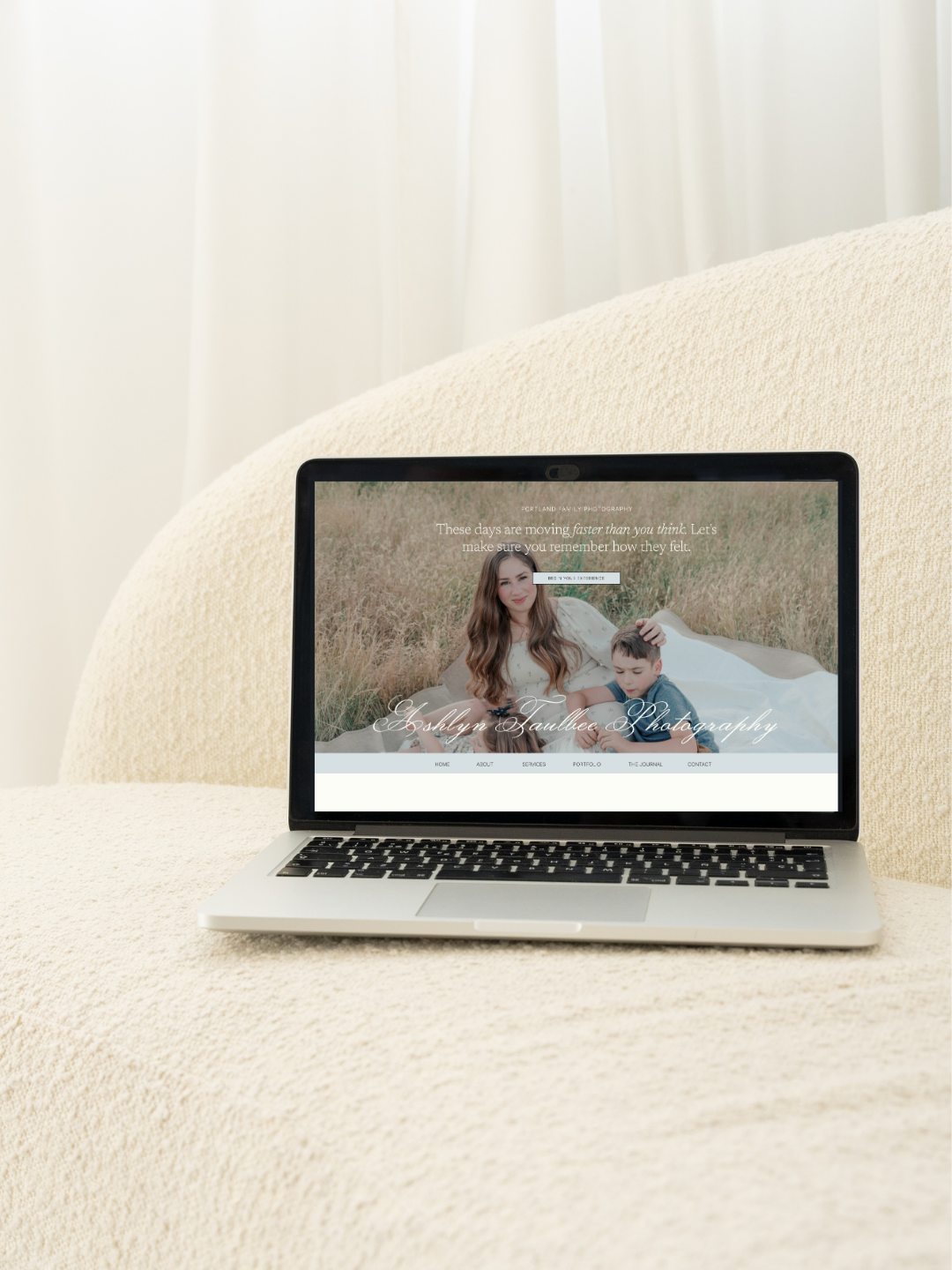 Open laptop displaying a photography website created by the brand darkroom
