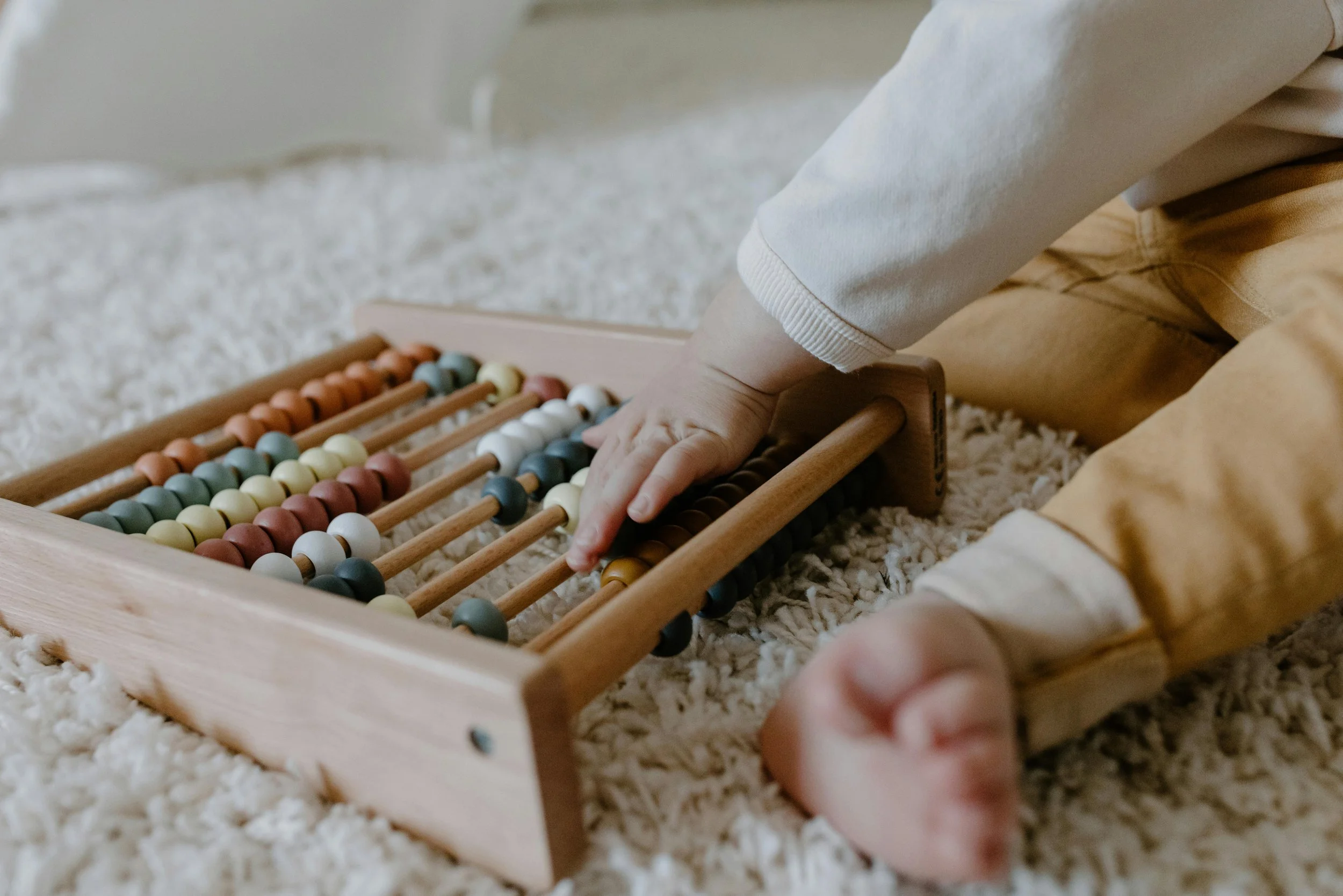 Child quietly playing with an age appropriate toy indoors